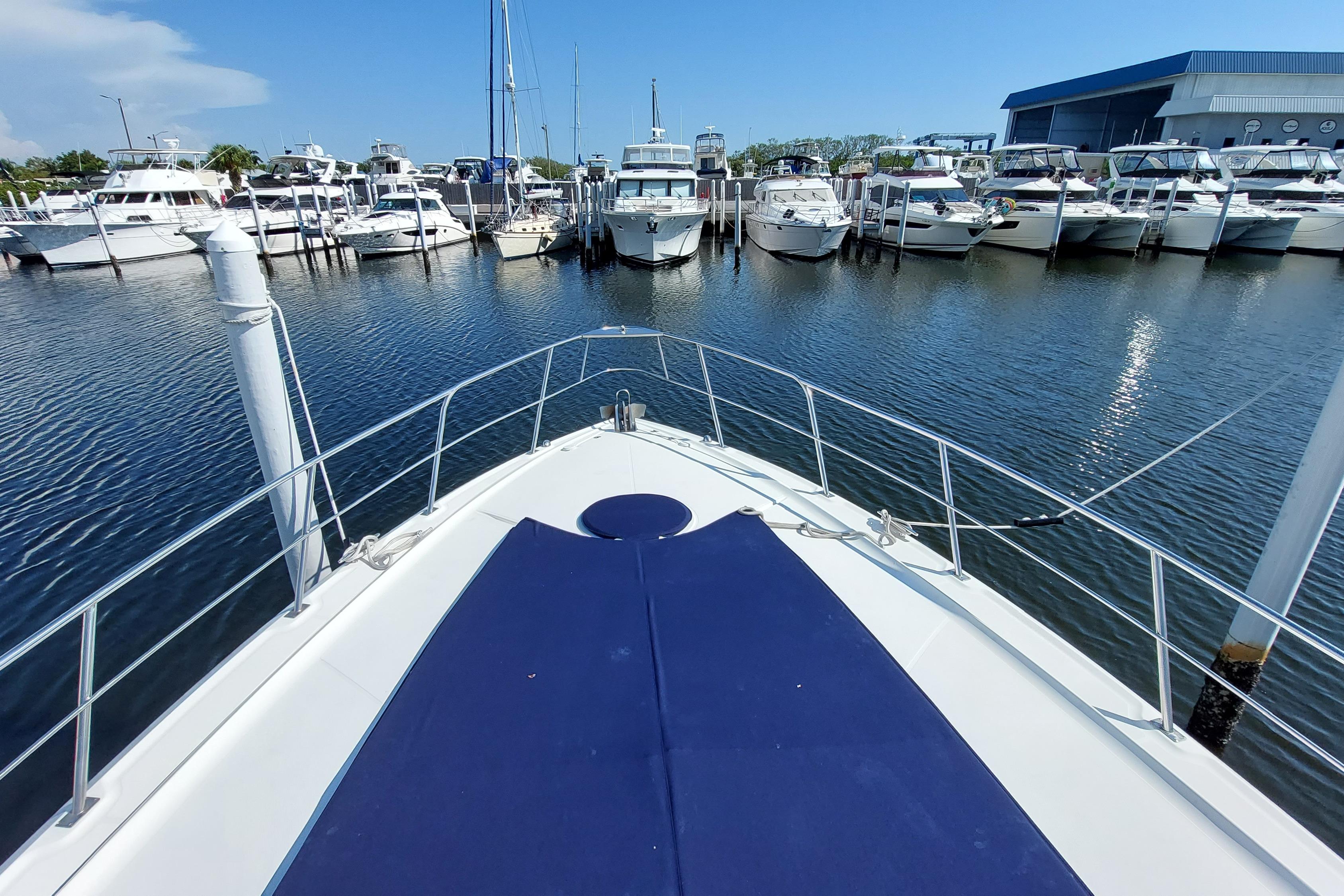 Bow view of 2006 Cruisers Yachts 520 Express docked at marina.