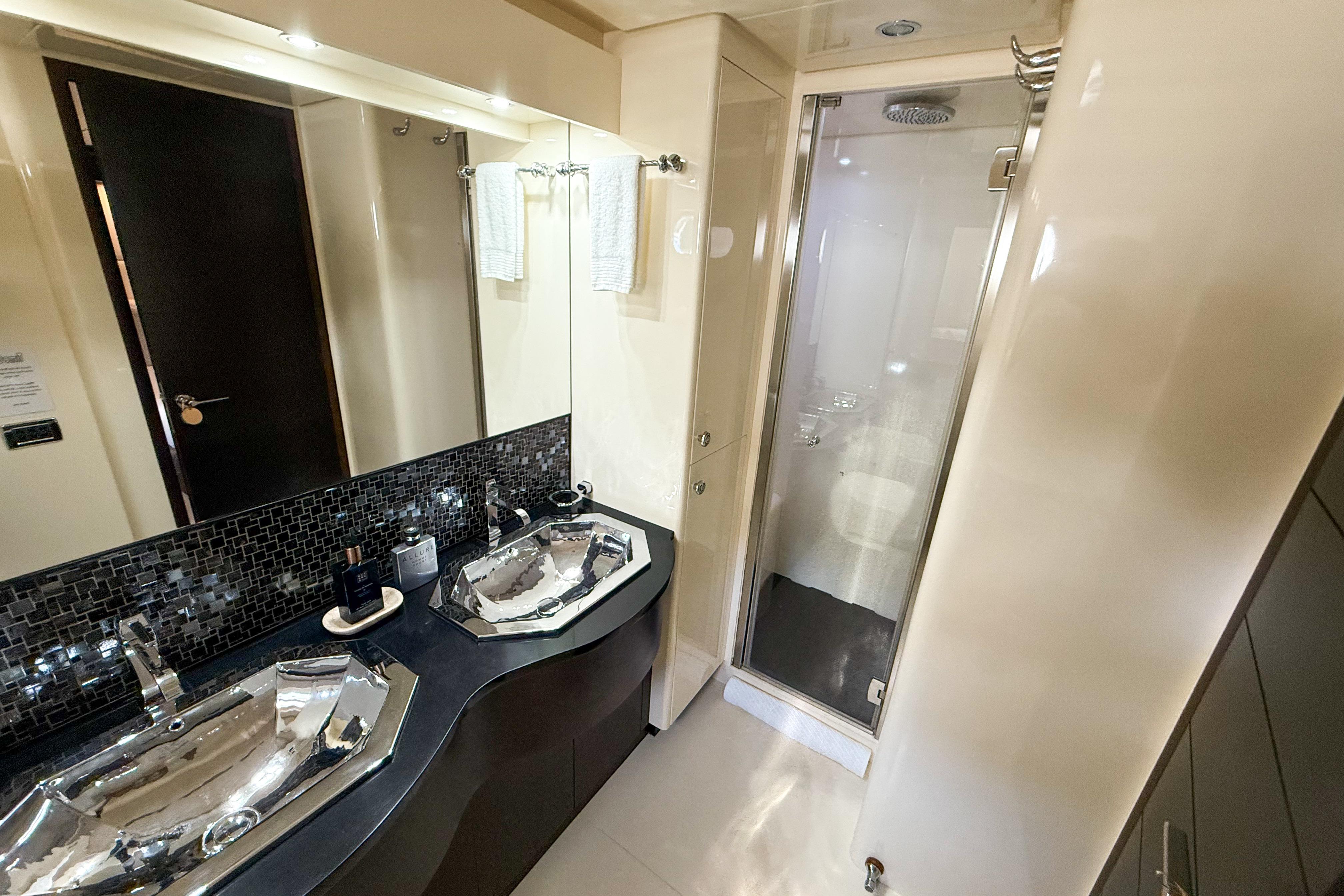 Luxurious bathroom in 2007 Canados 86 yacht with dual sinks and modern shower.