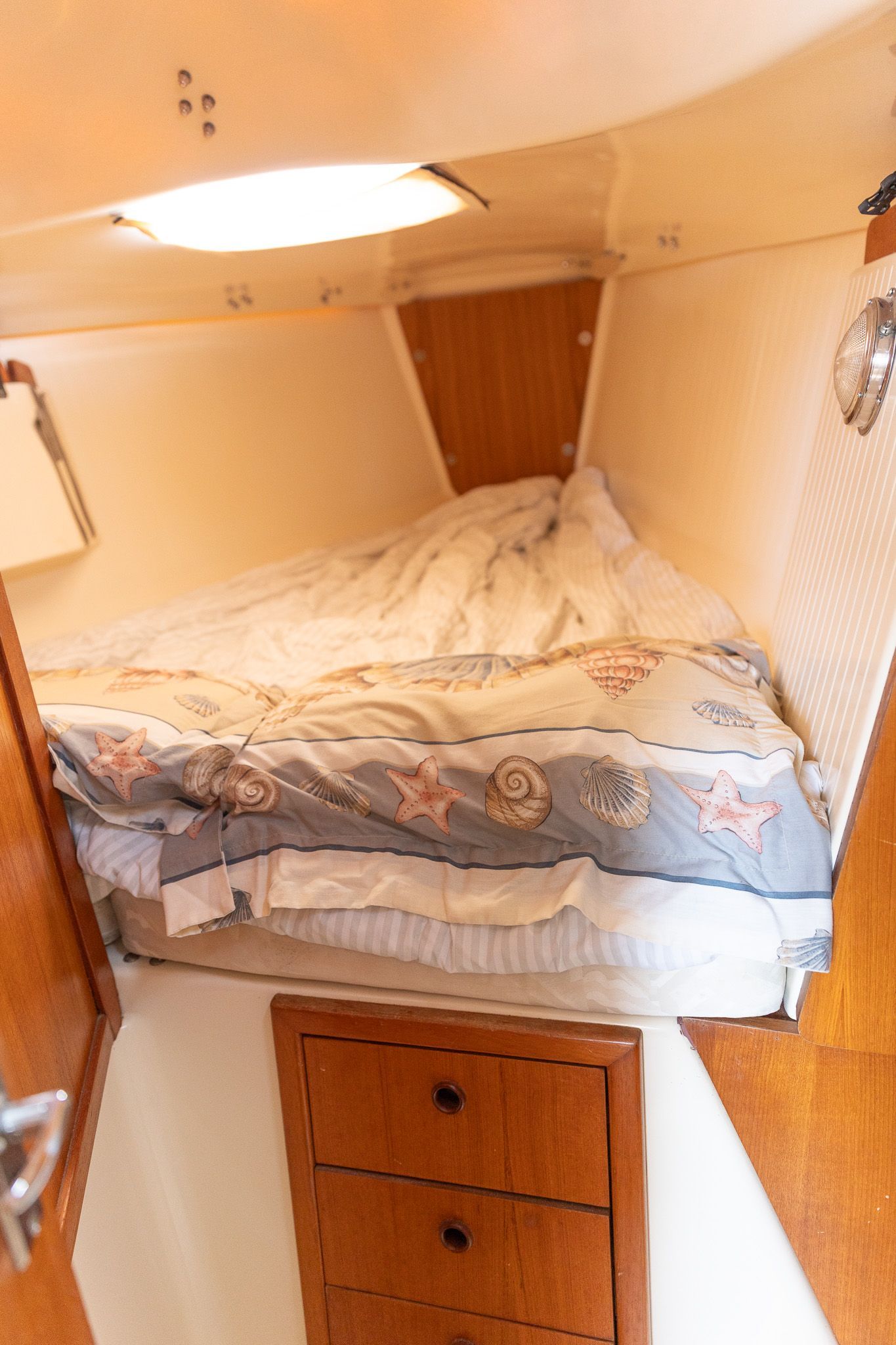 Interior of a 2004 Hake Seaward 32RK yacht with cozy bed.