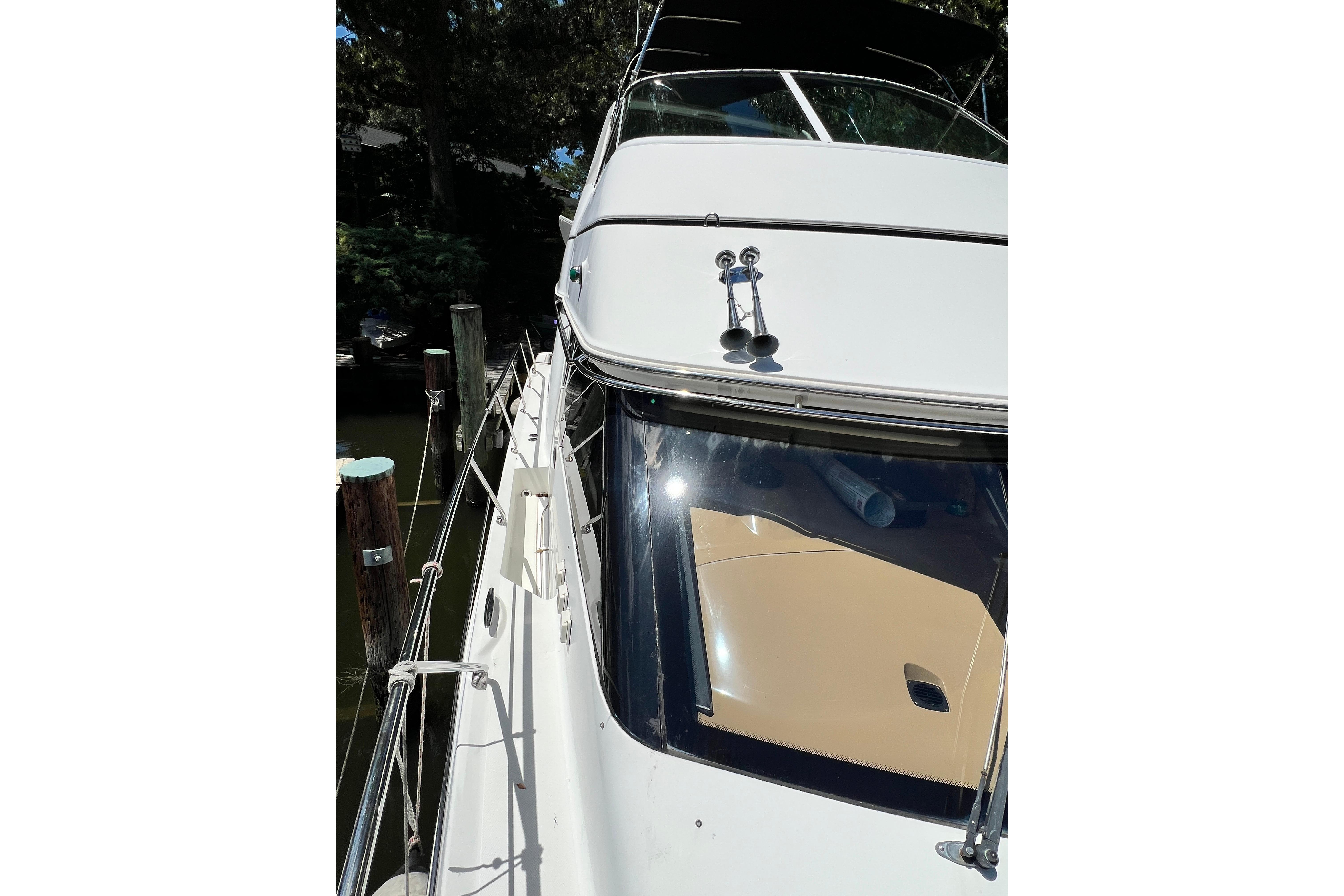 2003 Carver 450 Voyager Pilothouse yacht docked, showcasing sleek design and polished exterior.