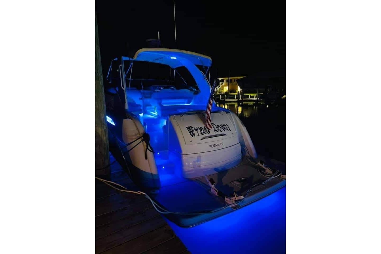 2003 Formula 40 Performance Cruiser illuminated with blue lights at night, docked in Kemah, TX.