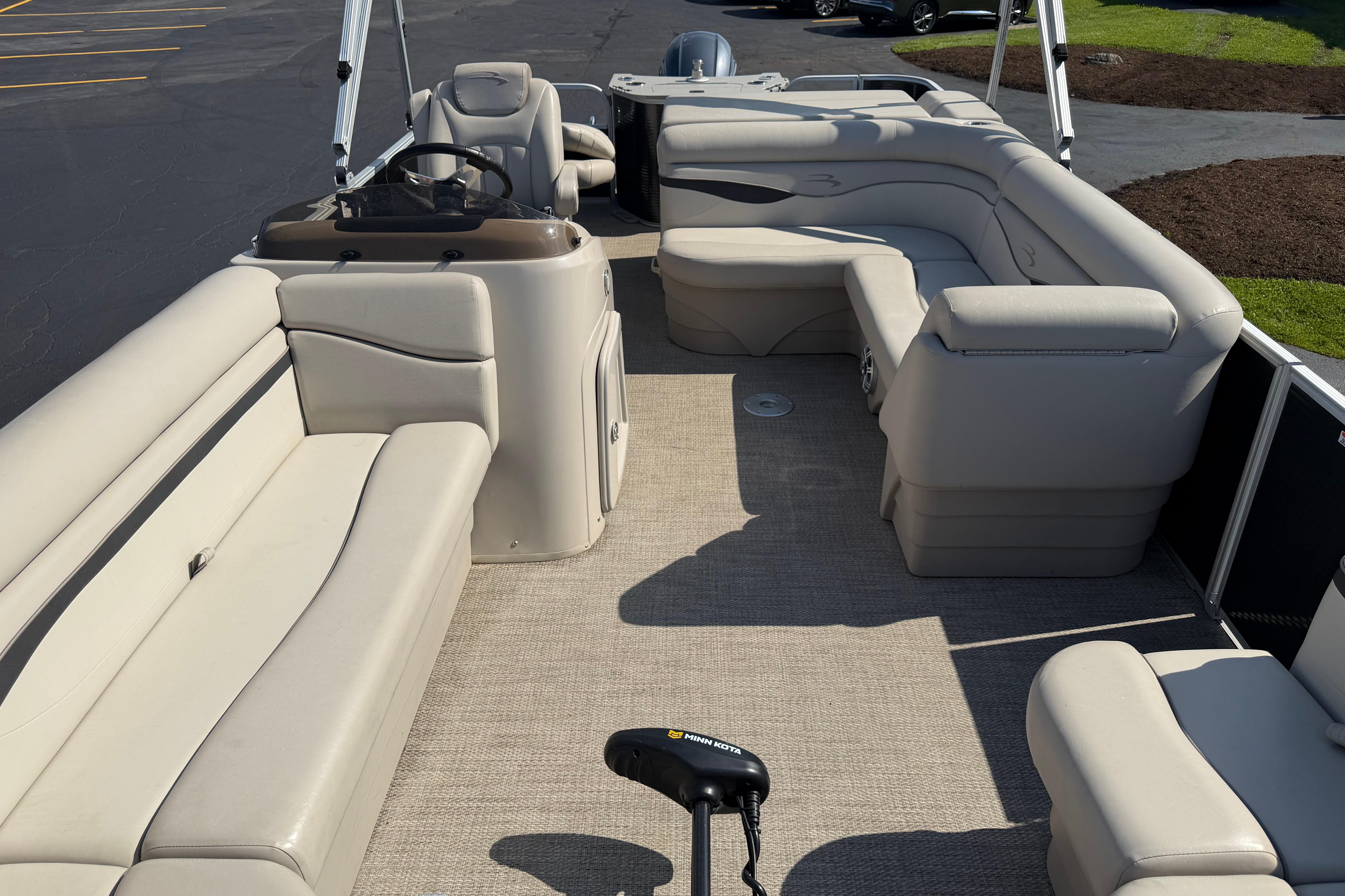 2018 Bennington 21 SF pontoon boat with spacious beige seating and steering console.