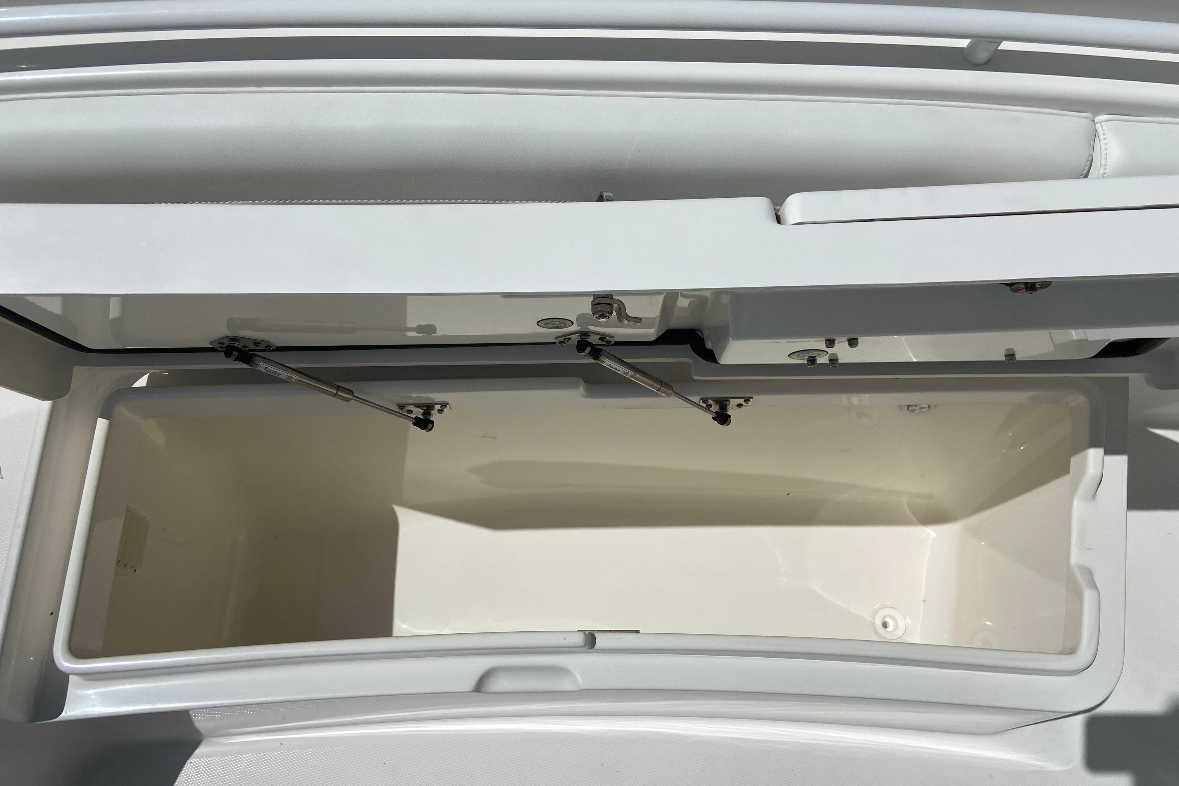 Open storage compartment on a 2021 Regulator 28 boat, showcasing interior space.