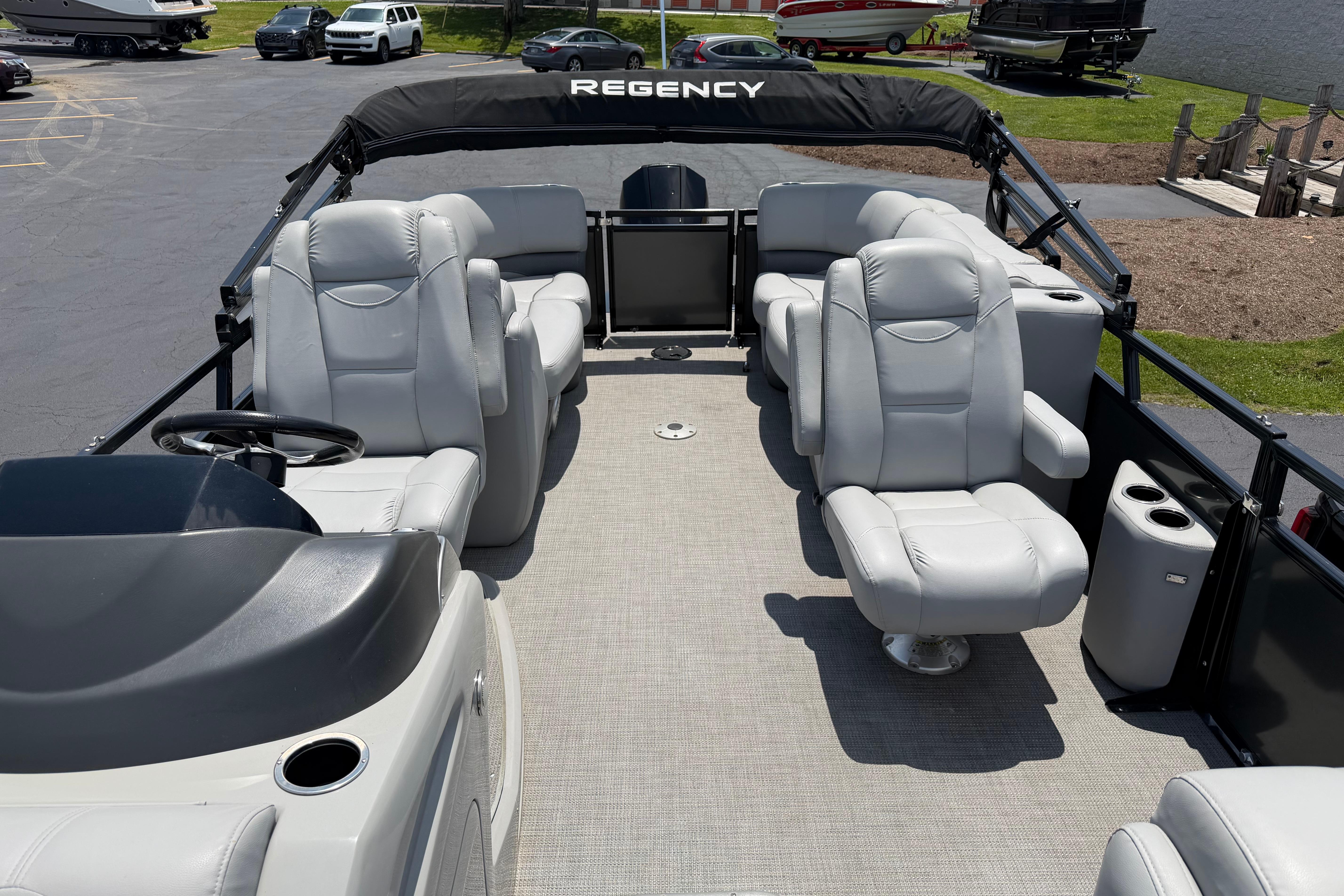 2019 Regency 230 DL3 pontoon boat with luxurious seating and modern design.