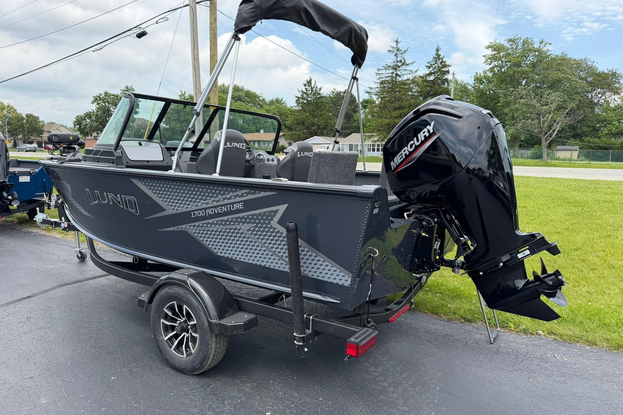 2027 Lund 1675 Adventure Sport boat with Mercury engine on trailer.