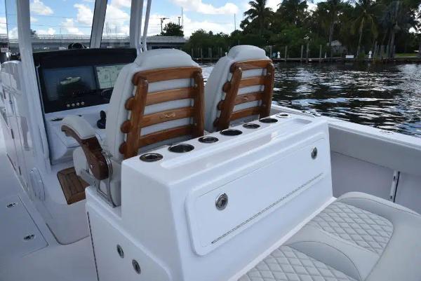 Manufacturer Provided Image: Luxury seating on a 2026 Jupiter 380LS boat with elegant wood accents and water view.