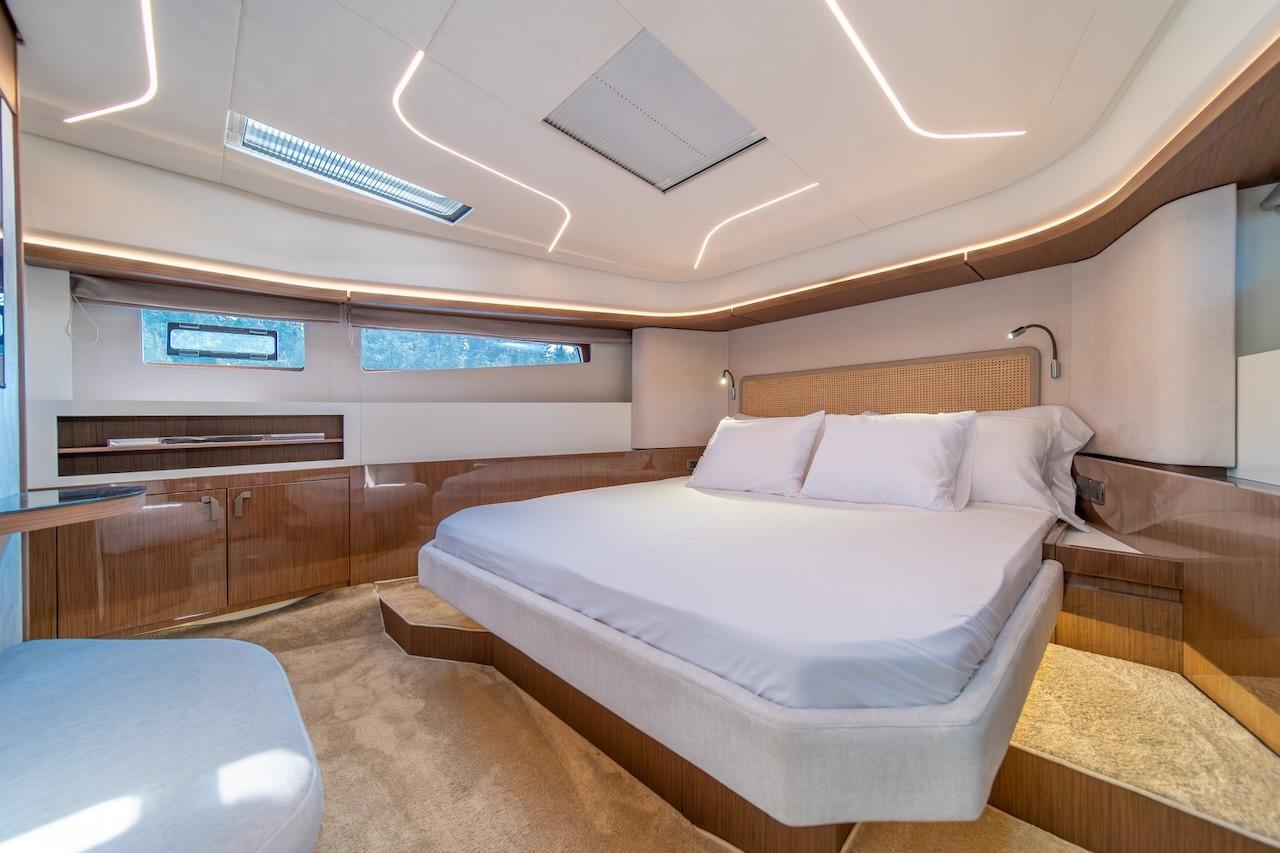 Luxurious 2025 Prestige F4.9 yacht bedroom with modern design and ambient lighting.