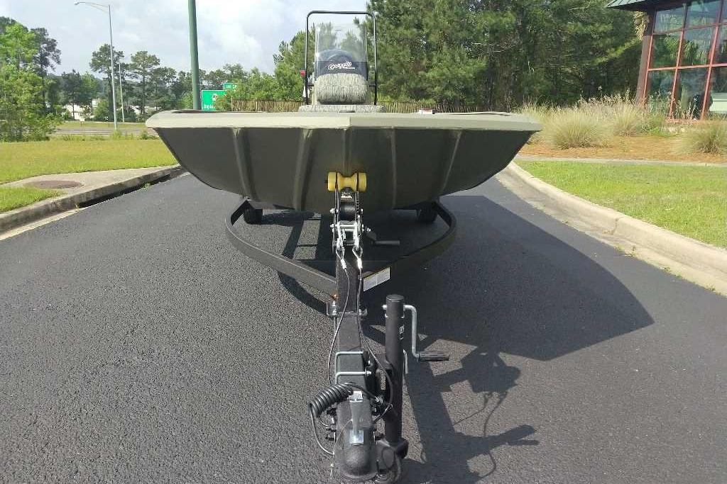 2026 Tracker Grizzly 1860 CC boat on trailer, parked on asphalt road.