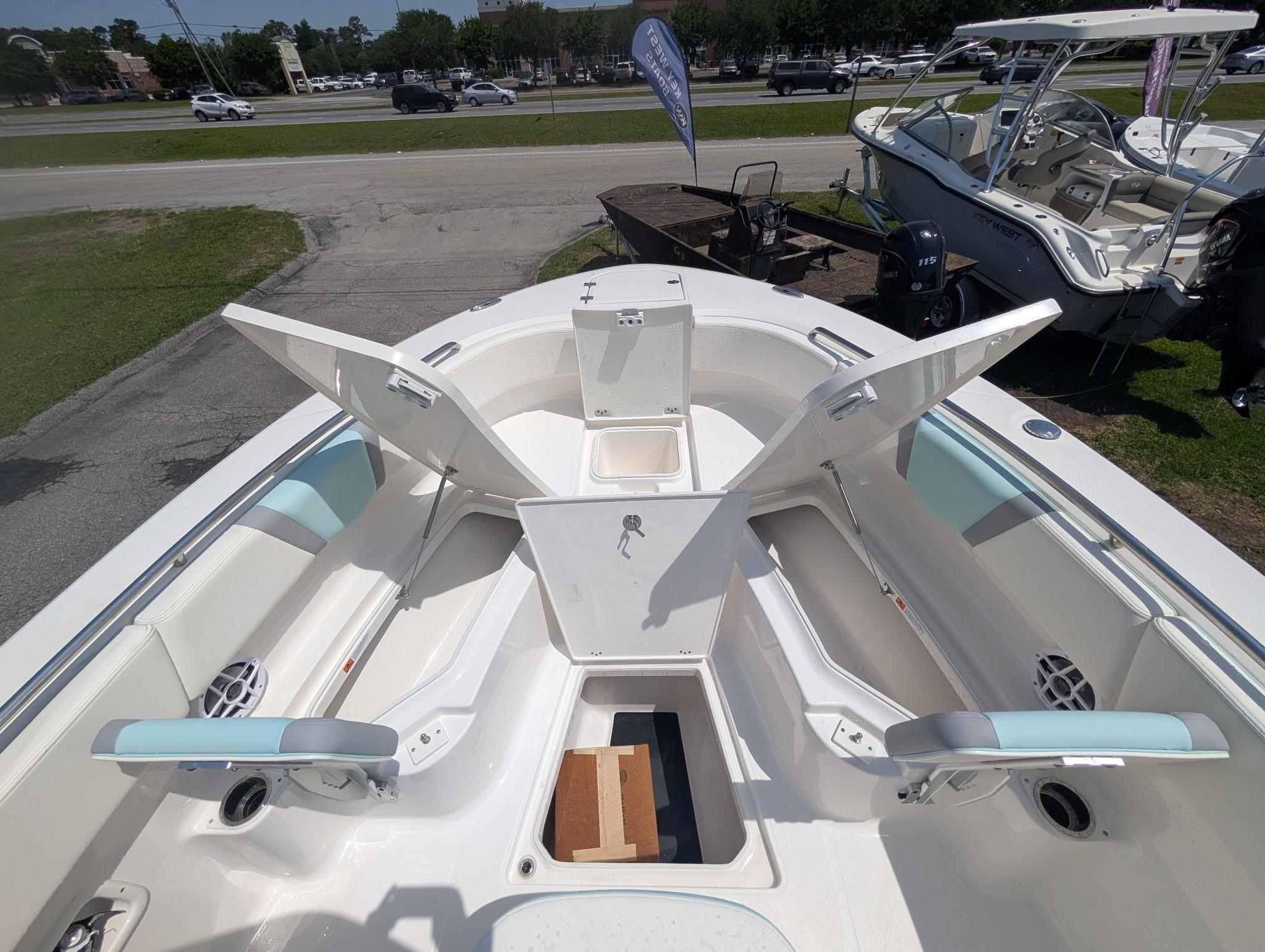 2025 Robalo R250 Center Console boat with open storage compartments and seating.