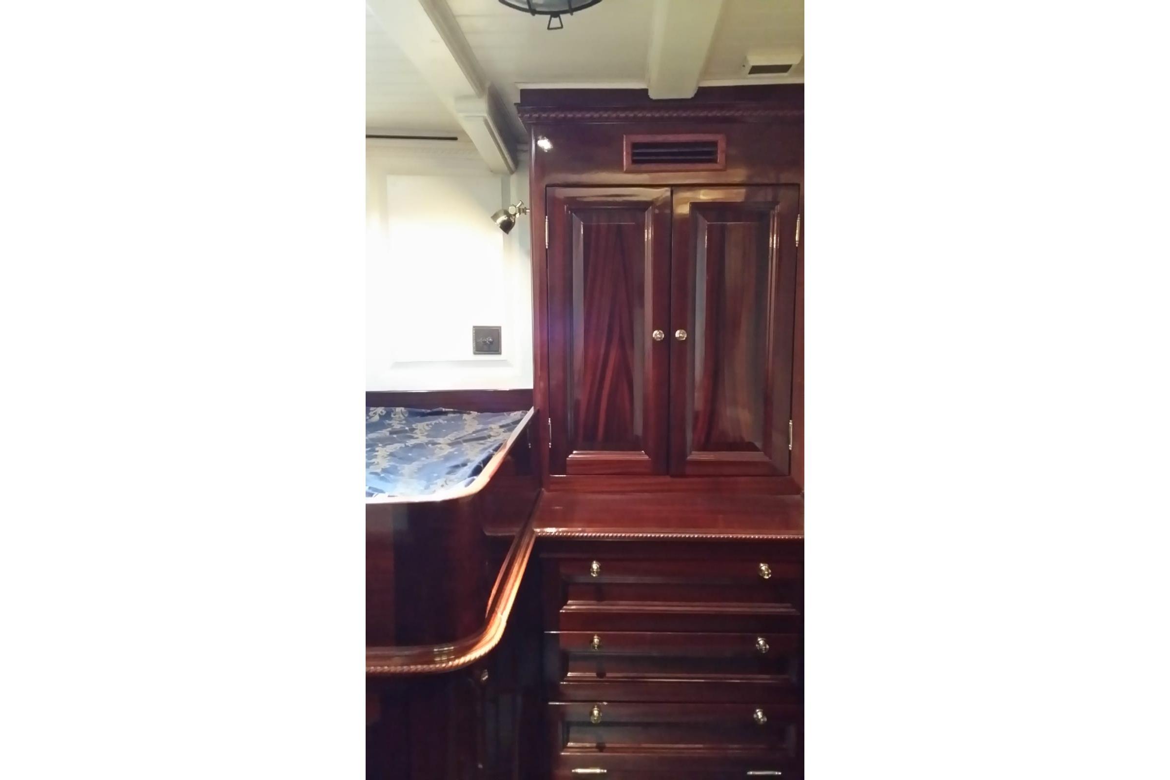 Luxurious wooden interior of 1930 Frederikksund Gaff Topsail Schooner cabin with elegant cabinetry.