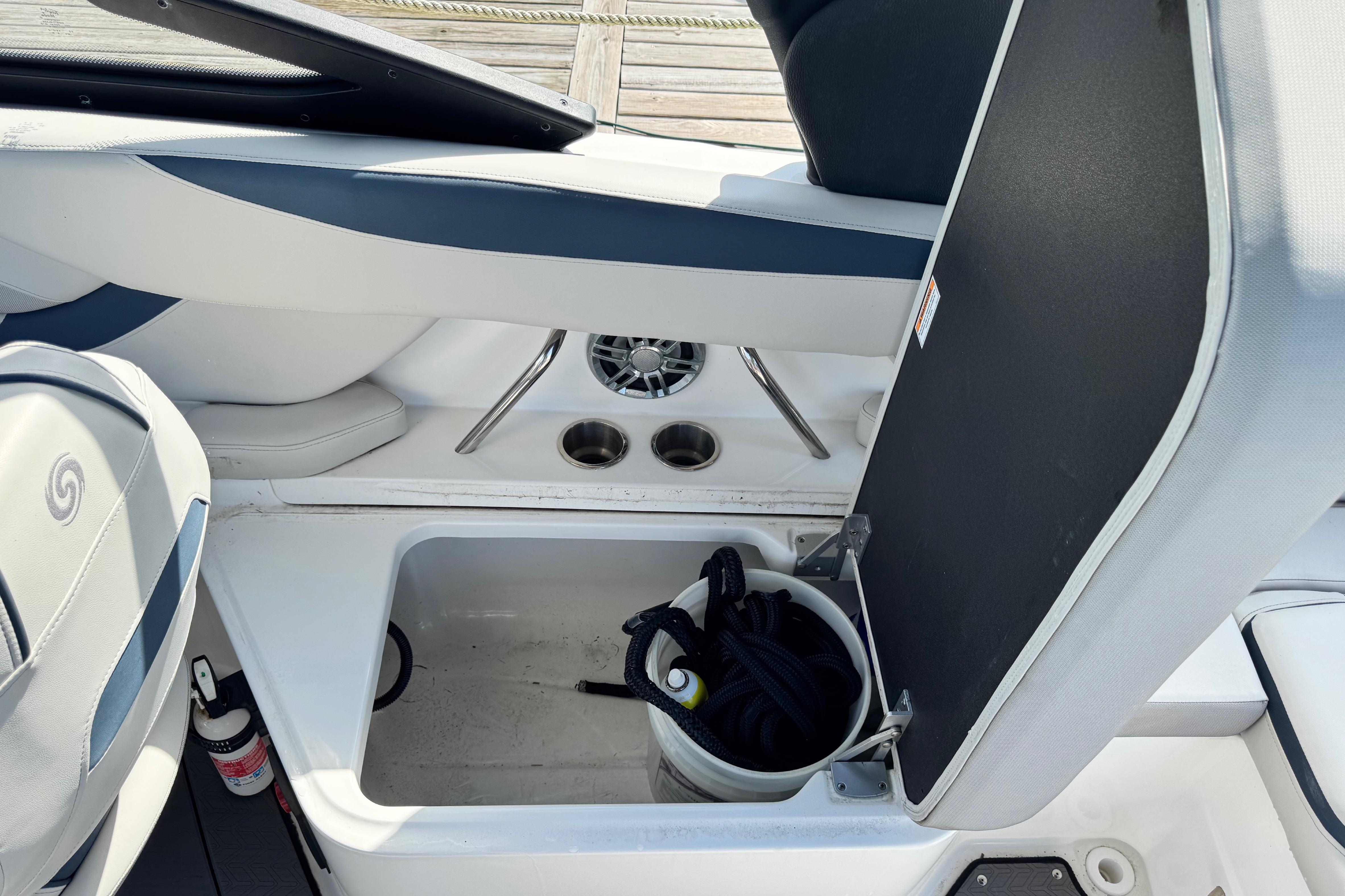 2023 Hurricane SunDeck 2600 OB boat interior storage compartment with bucket and rope.