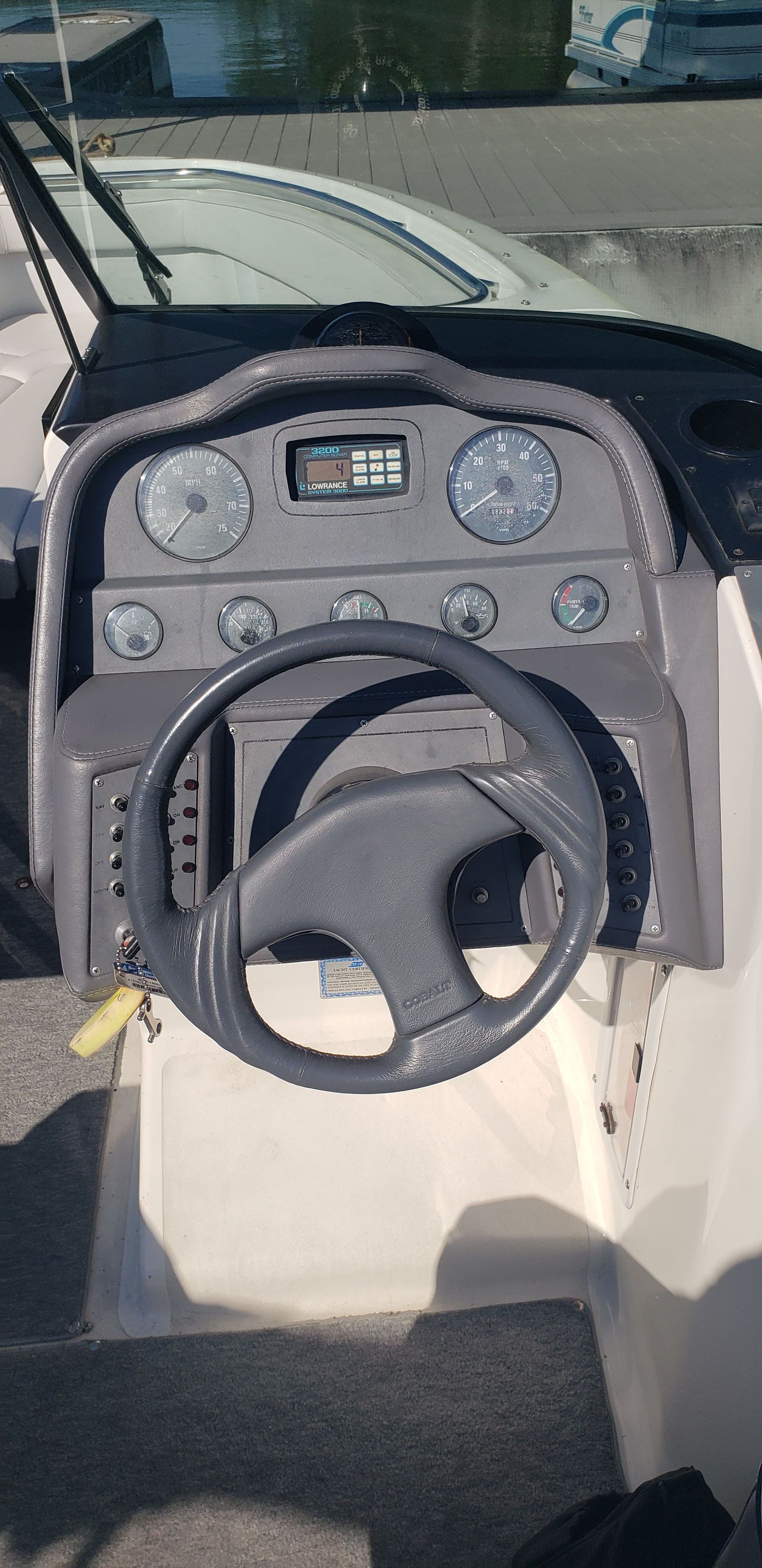 Dashboard of a 1993 Cobalt 272 boat with steering wheel and gauges.