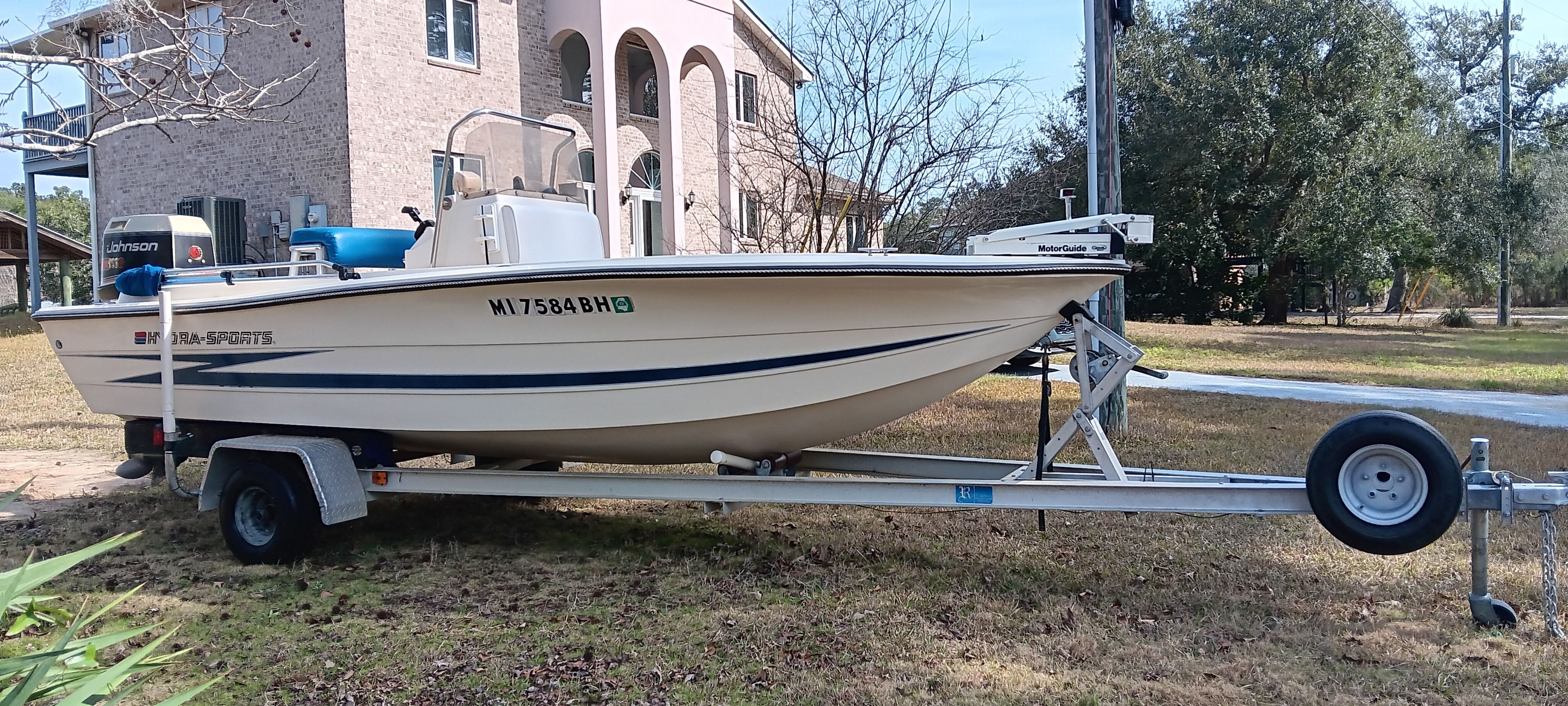 A 1990 Hydra-Sports Vector on a trailer in front of a house.