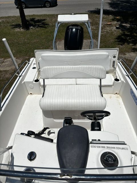 The image shows the cockpit of a 2008 Boston Whaler 200 Dauntless with white seating.