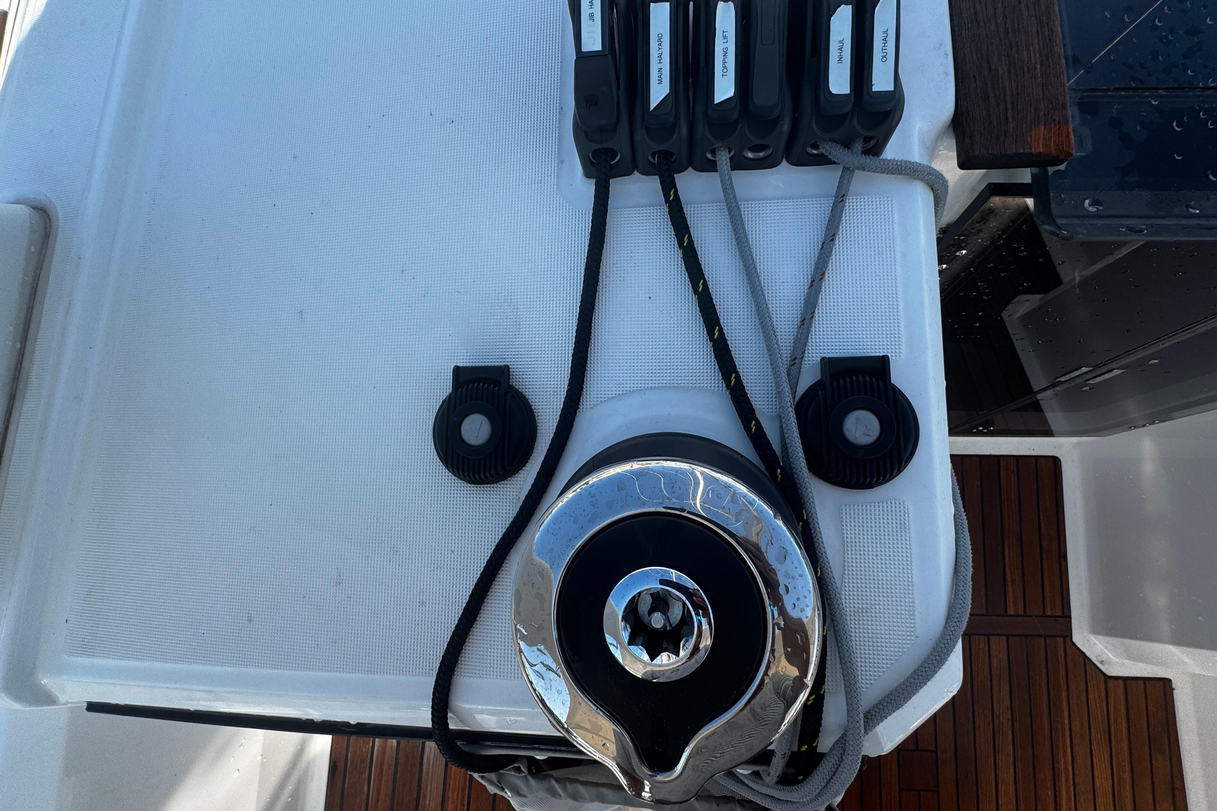 Winch and rope setup on 2023 Beneteau Oceanis 38.1 sailboat deck.