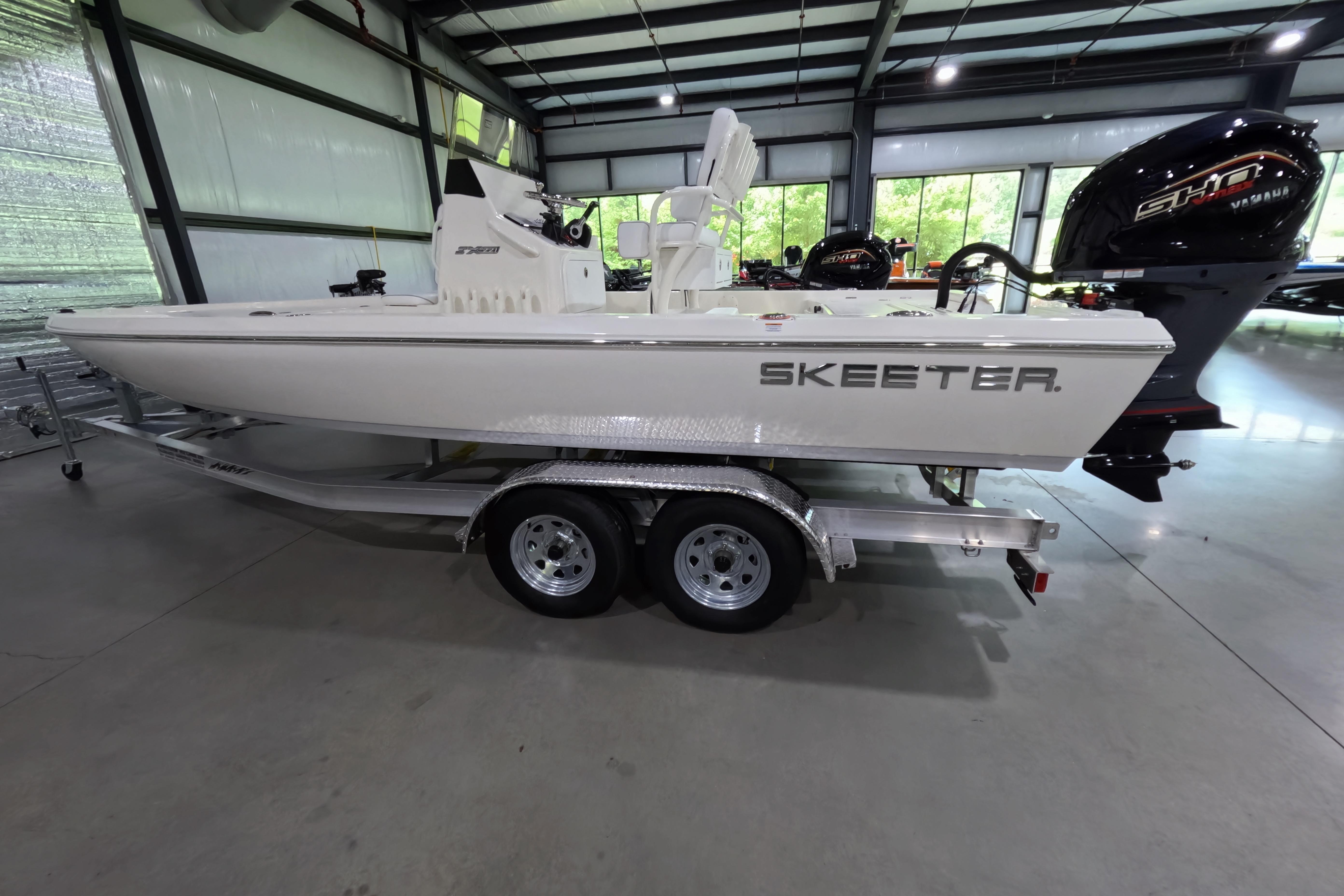 2026 Skeeter SX221 boat on trailer in indoor showroom.