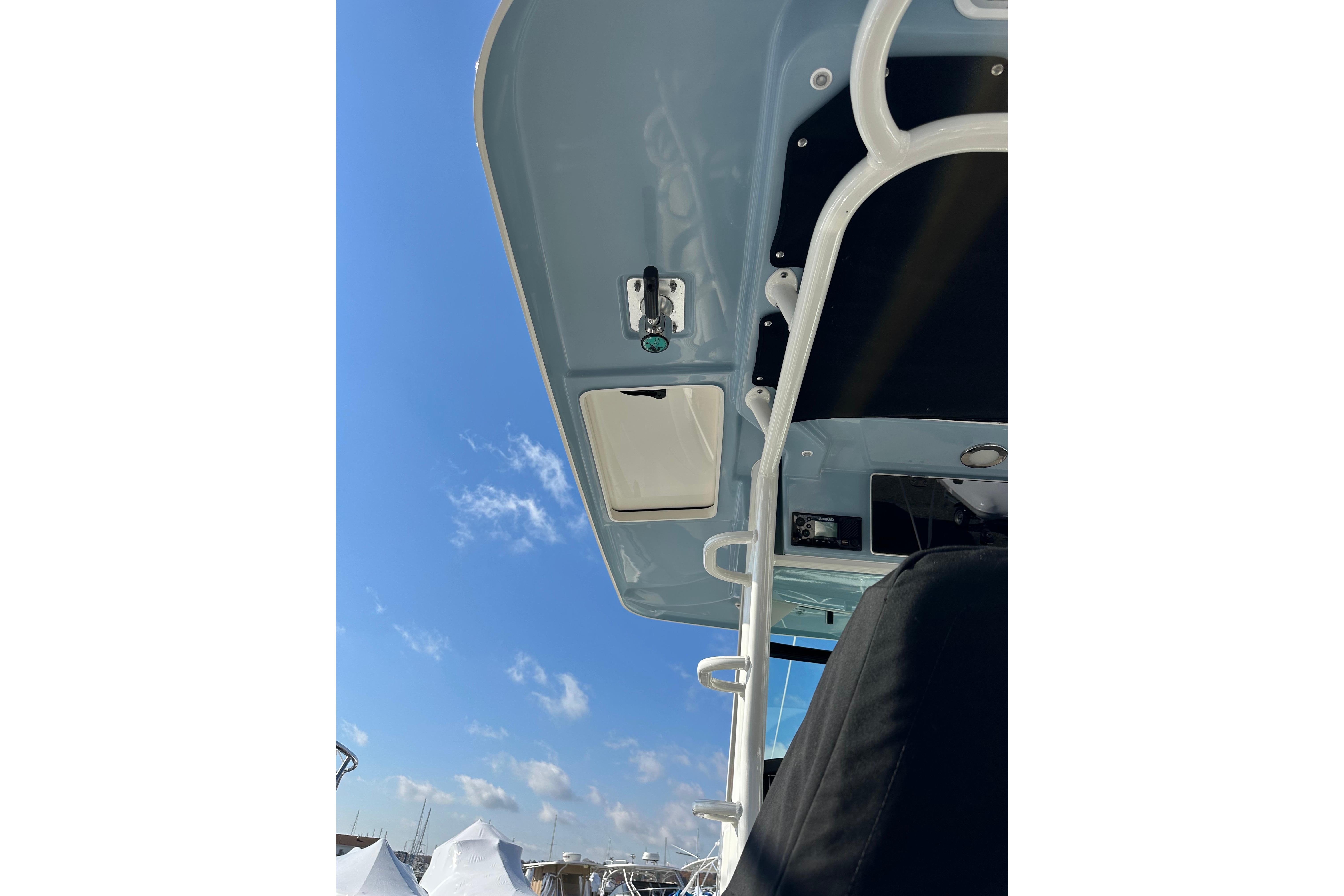 2023 Boston Whaler 330 Outrage boat canopy against a clear blue sky.