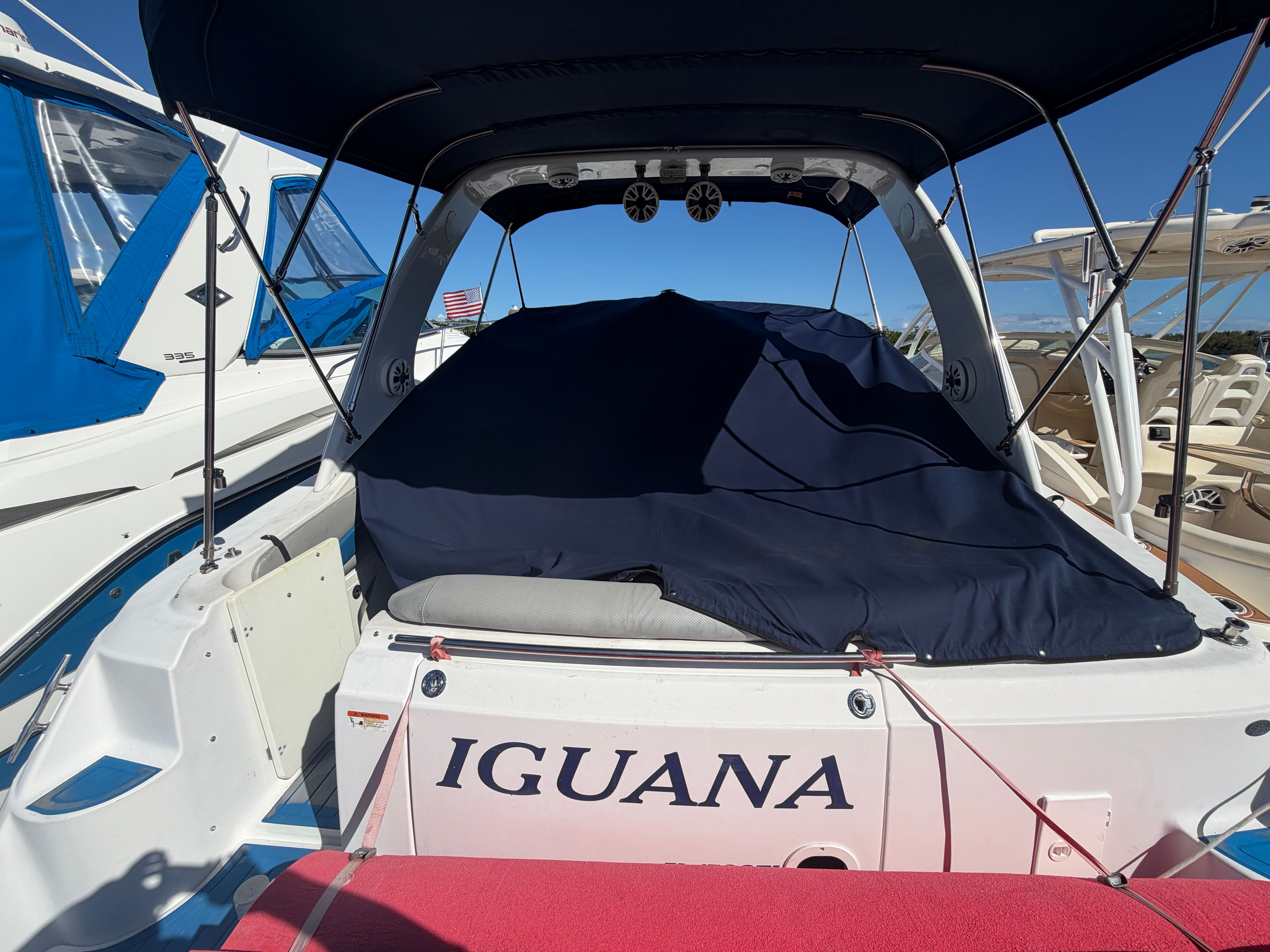 2006 Four Winns 328 Vista boat with cover in marina.