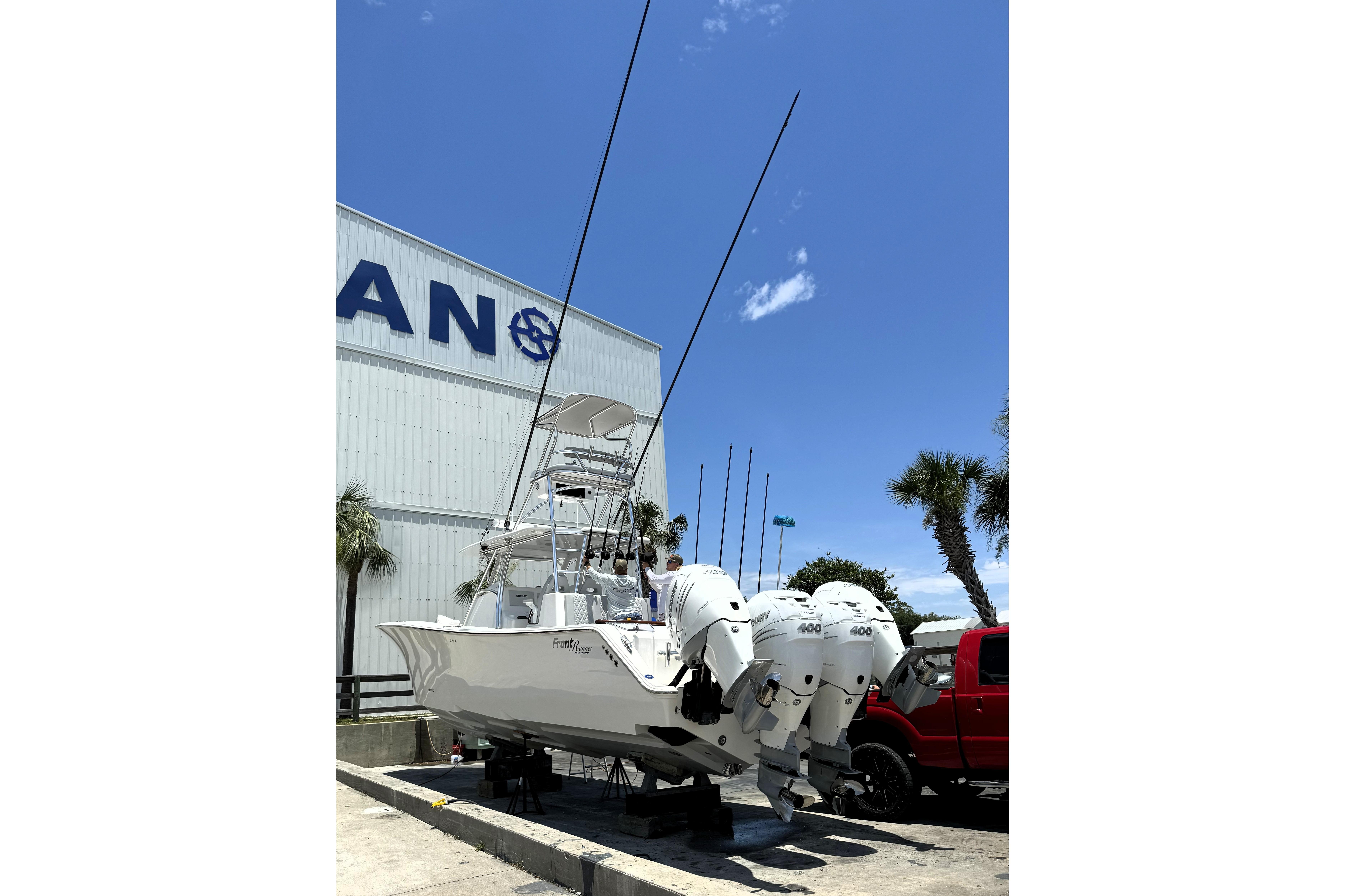 2020 Front Runner 39 Center Console boat with multiple engines, parked near a building.