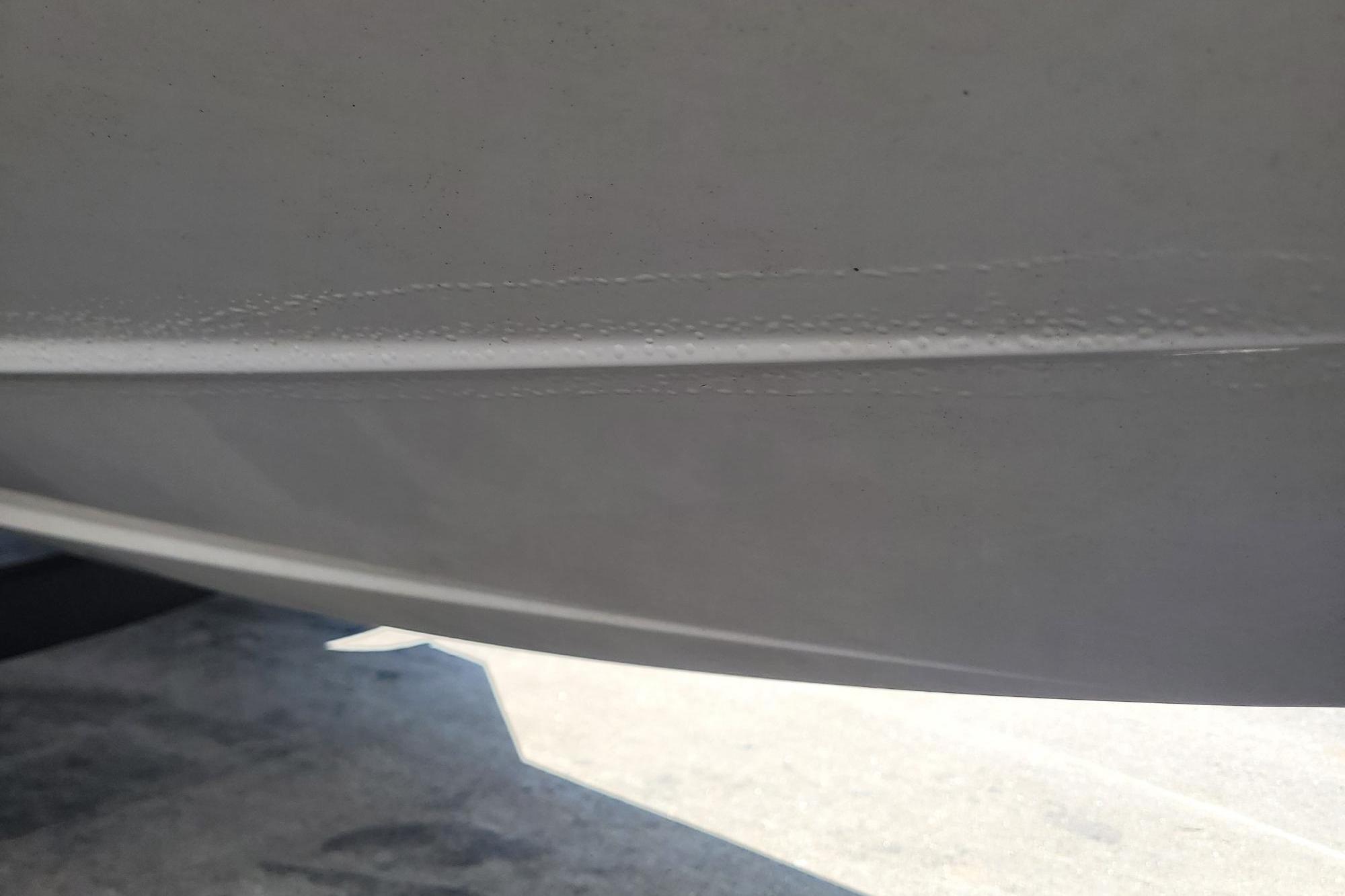 Close-up of 2024 Tahoe 1950 boat hull, showing smooth white surface.