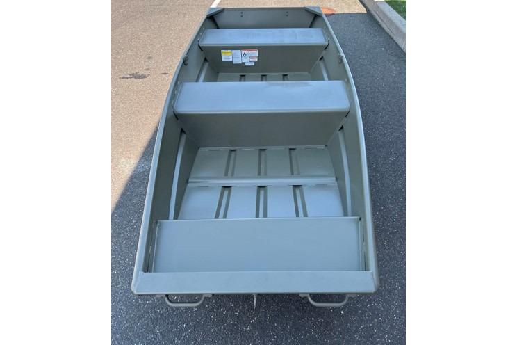 2026 Tracker Grizzly 12 Jon boat on pavement, showcasing interior seating and structure.