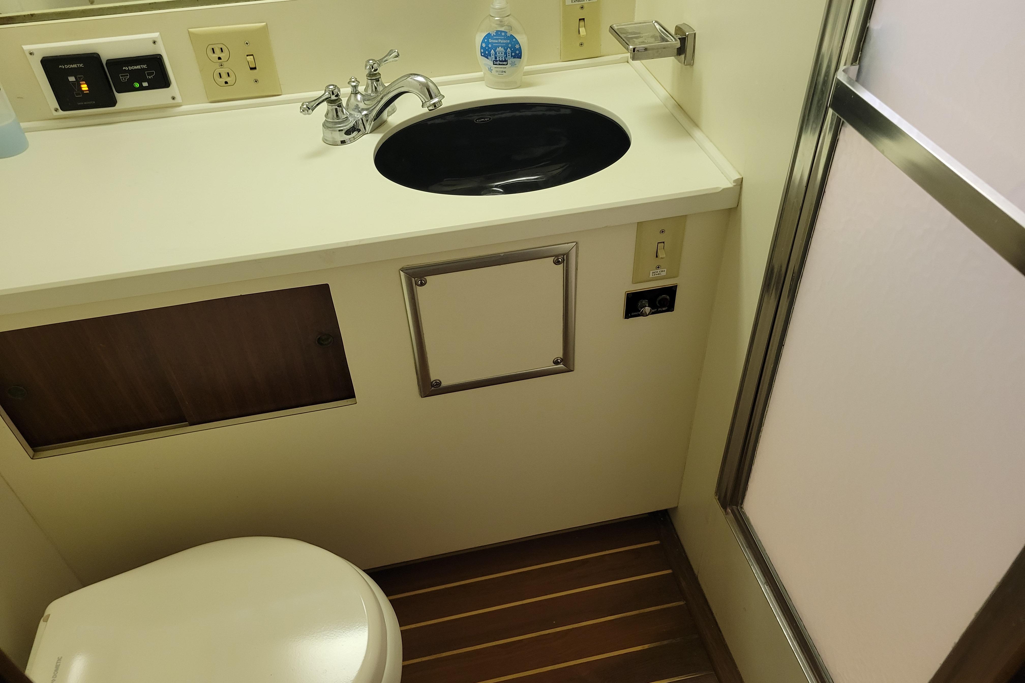 Bathroom interior of 1980 Hatteras 53 Yacht Fisherman with sink and shower.