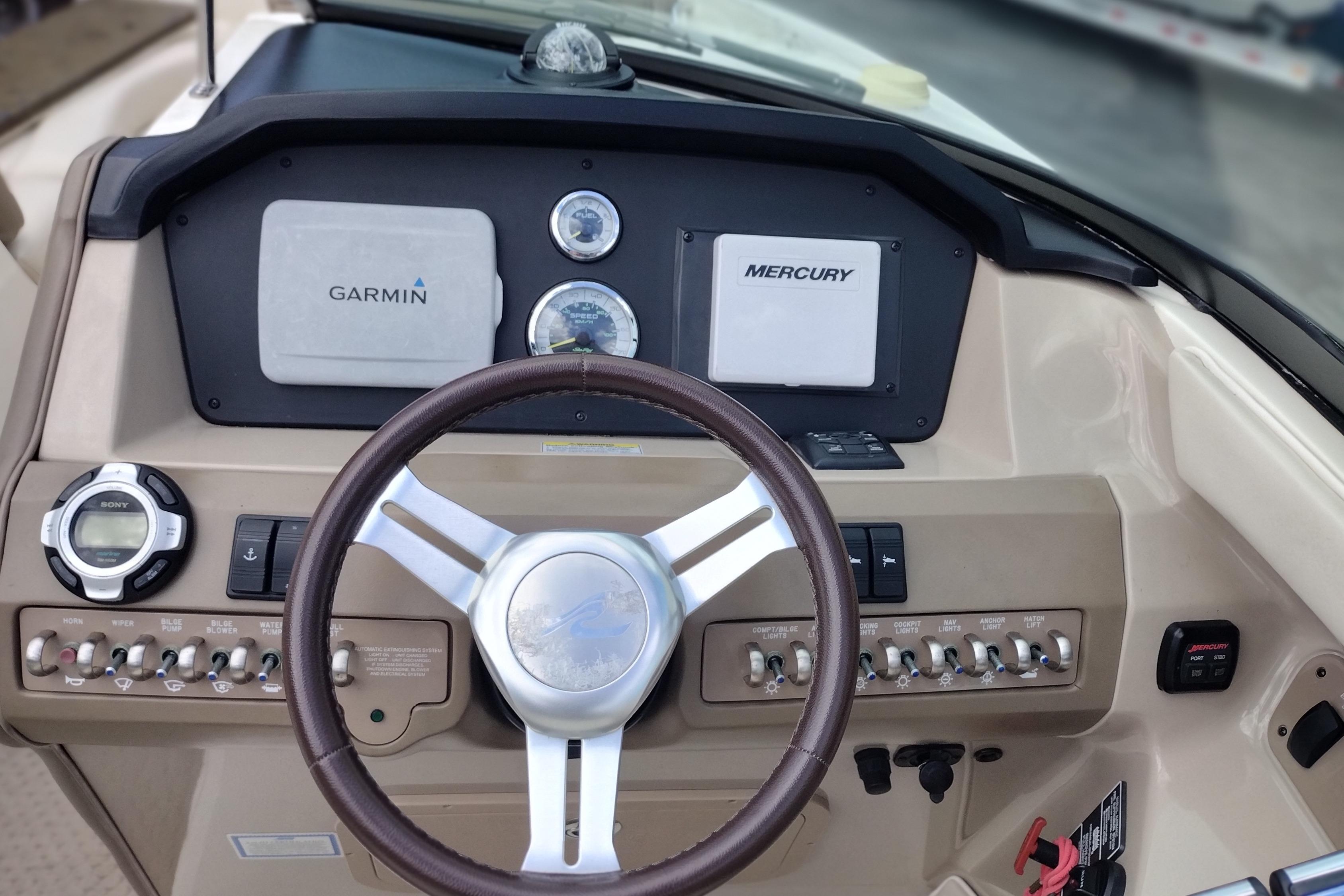 Dashboard of a 2013 Sea Ray 300 SLX boat with Garmin and Mercury displays.