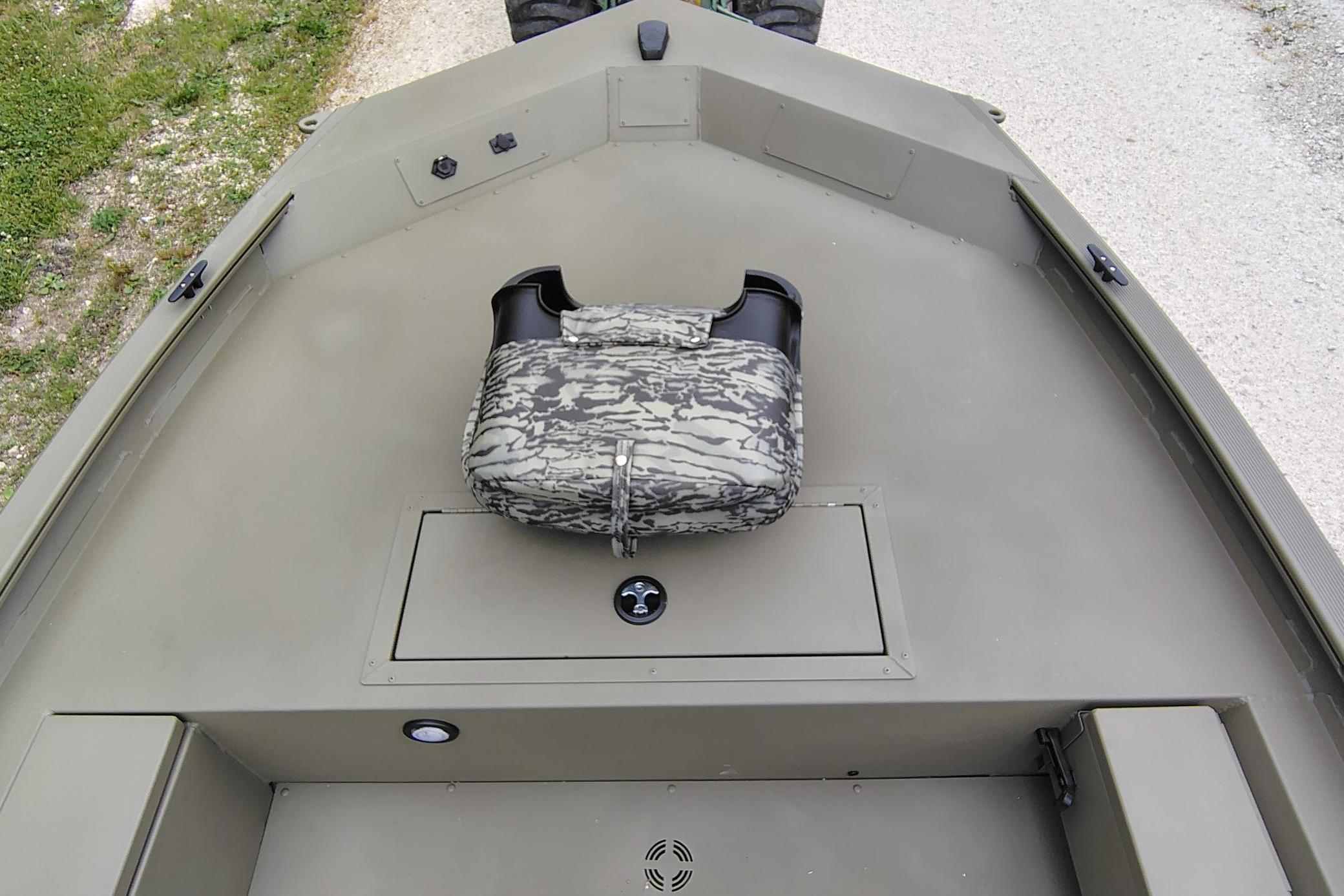 2026 Tracker Grizzly 1654 T Sportsman boat interior with camouflage seat and storage compartment.