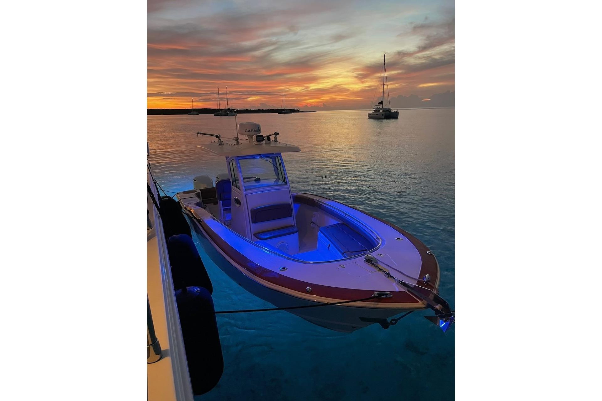 2013 Scout 275 LXF boat at sunset, anchored in calm waters.