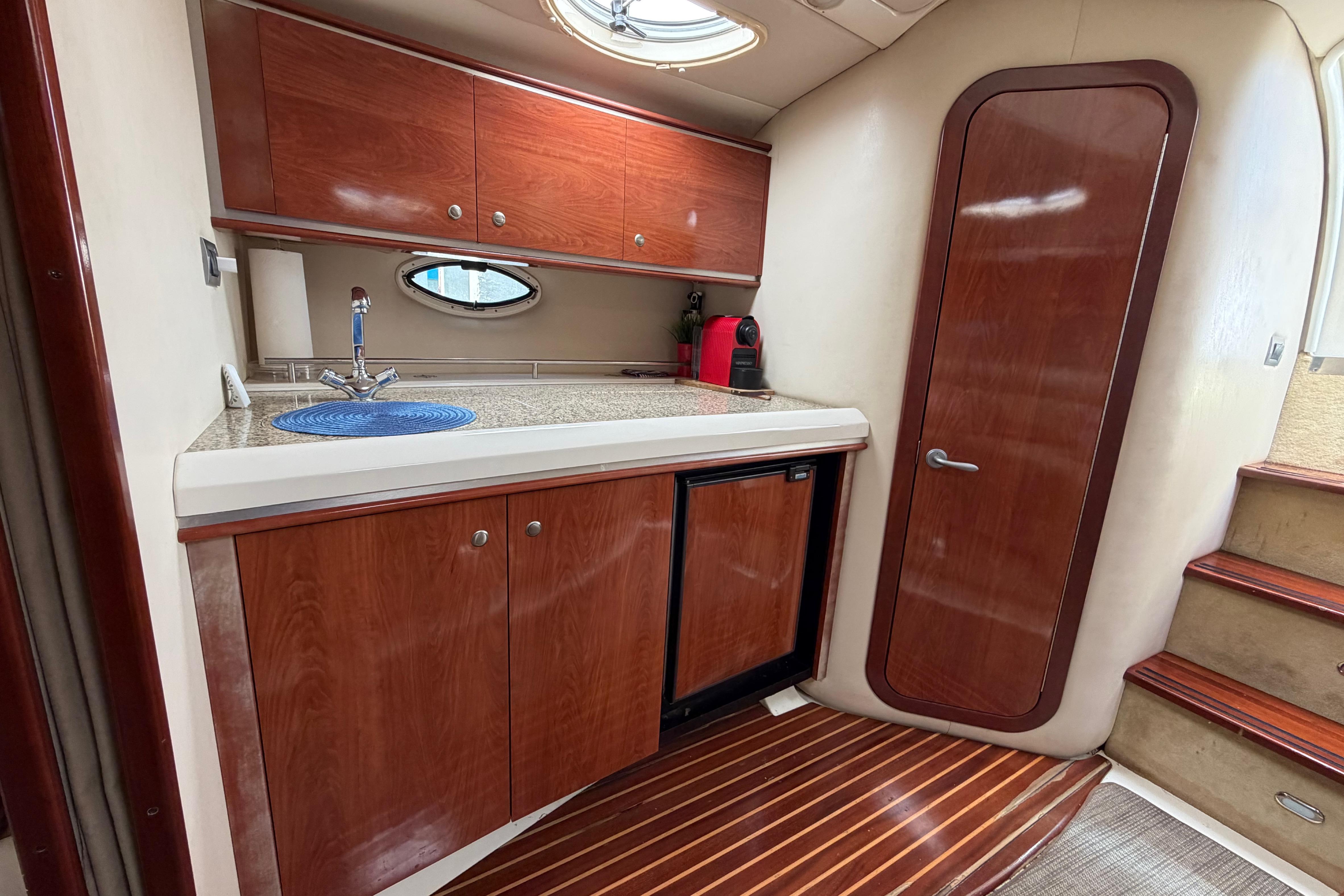 2007 Monterey 350 Sport Yacht interior with wooden cabinetry, compact kitchenette, and sleek design.