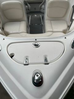 The image shows the bow of a Chaparral 190 SSi boat with white seats and a storage compartment.