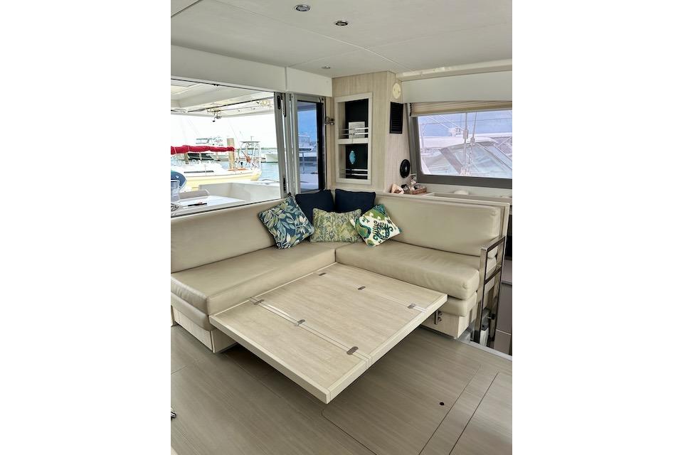 Luxurious interior of 2017 Leopard 40 yacht with beige seating and decorative pillows.