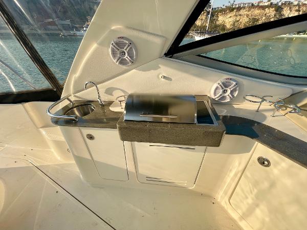 2014 Sea Ray 330 Sundancer boat interior with kitchenette and speakers.