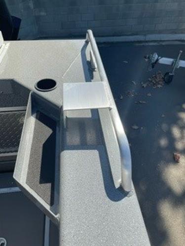2025 Spartan 2600 Olympia boat deck with railing and storage compartment.