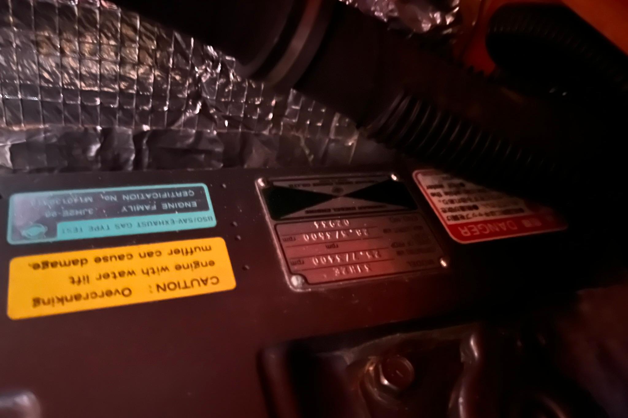 Engine compartment of a 1998 Sabre 362 with caution and danger labels visible.