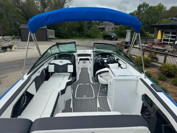 2018 Monterey 258 Super Sport boat with blue canopy and sleek interior design.