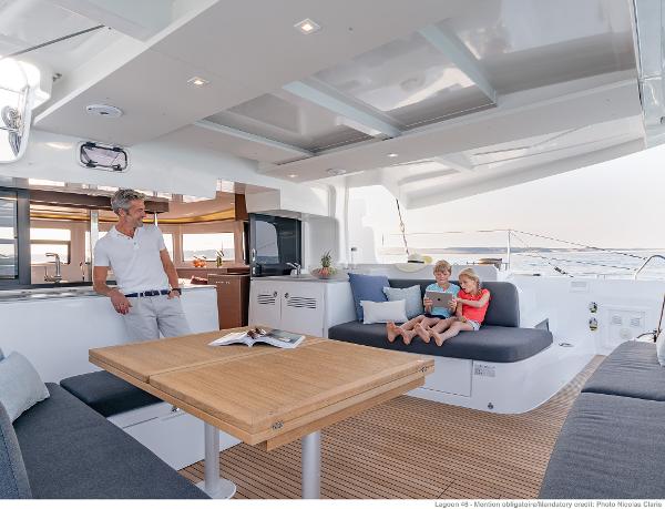 Family enjoying leisure time on the Lagoon 46 ICONIC yacht, 2025 model.