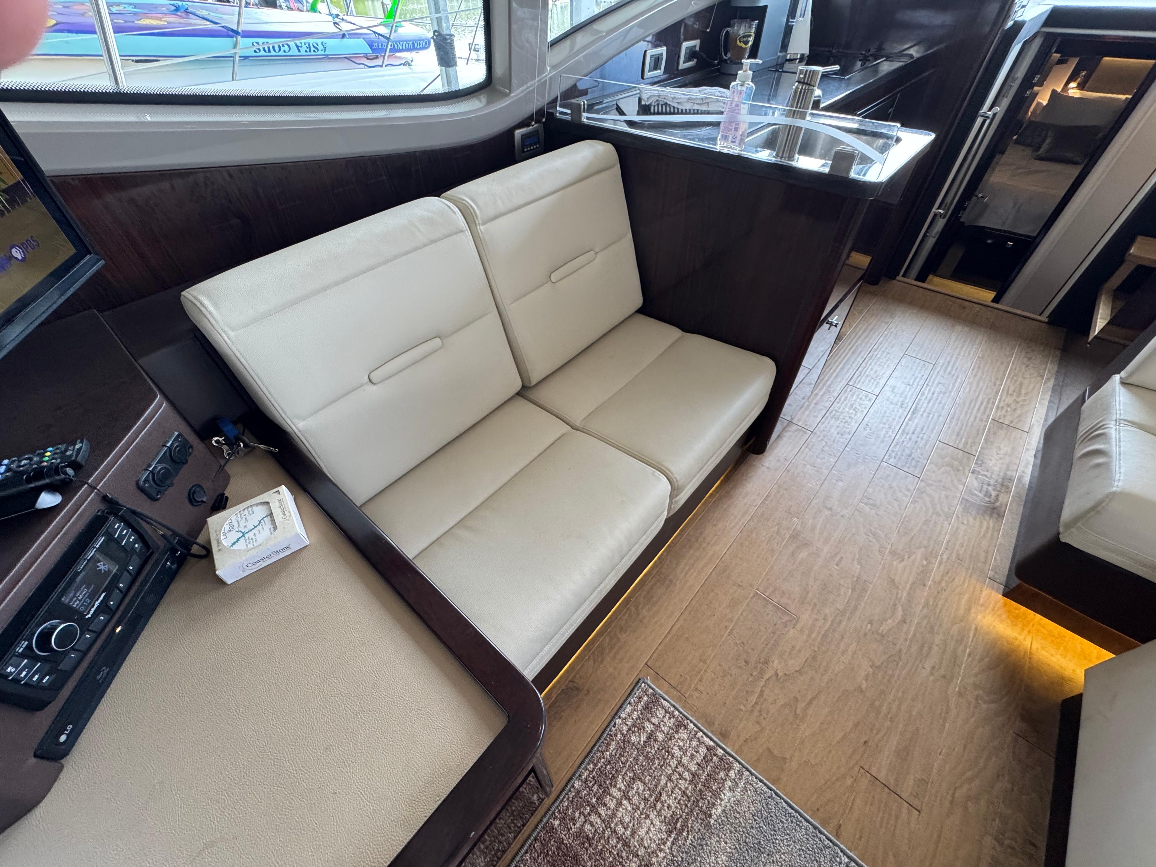 2017 Sea Ray Sundancer 400 interior with beige seating and wooden flooring.