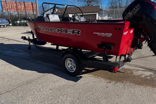 2026 Tracker Pro Guide V-175 WT boat on trailer, red exterior, parked outdoors.