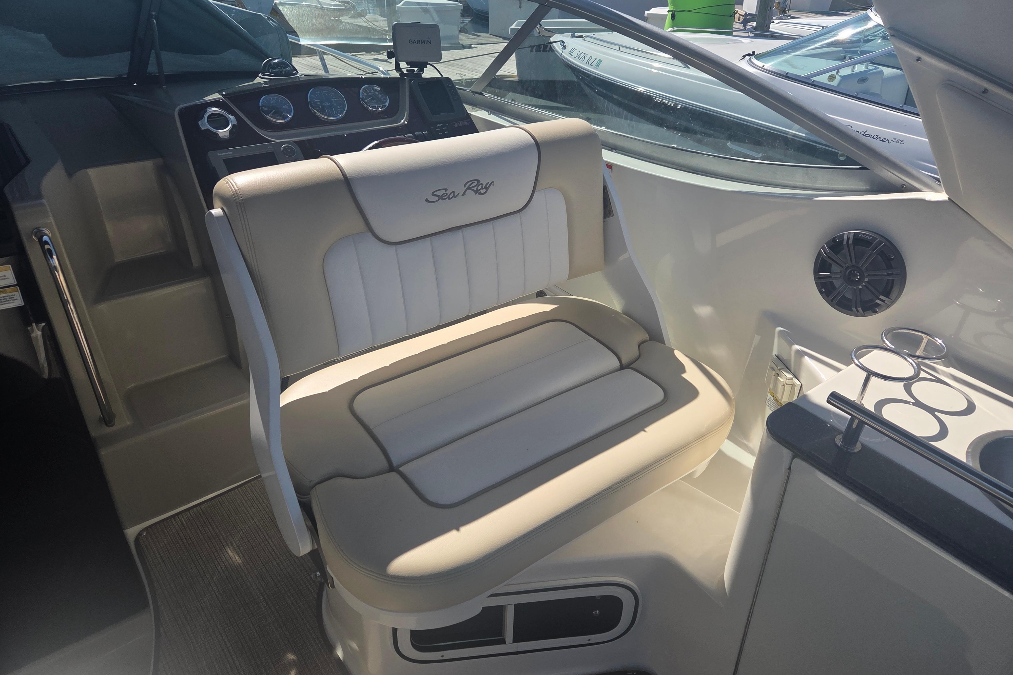 Interior of a 2012 Sea Ray Sundancer 260 boat with beige seating and dashboard.