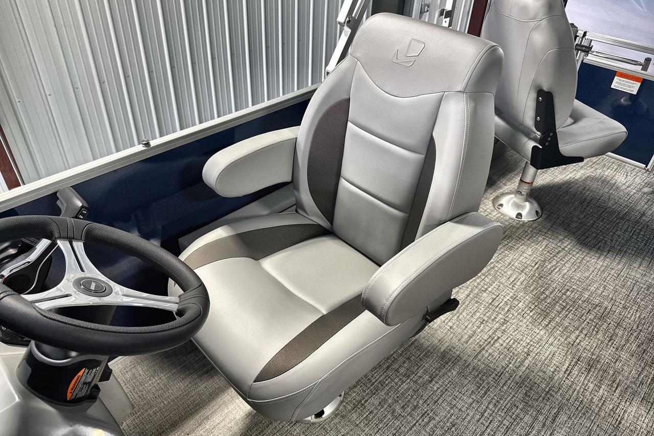 Captain's chair in 2026 Landau Island Breeze 23F pontoon boat, featuring sleek design and comfort.