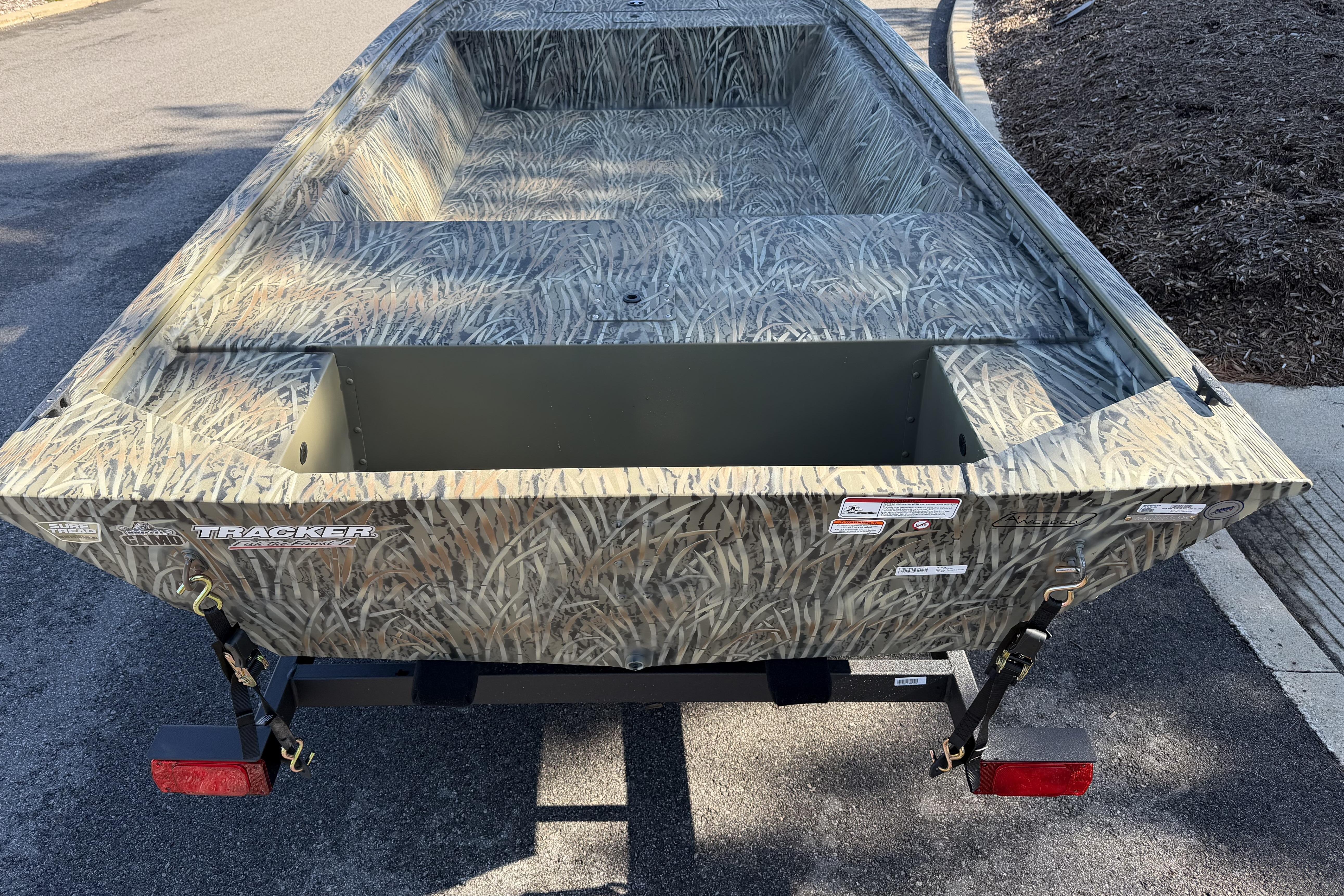 2026 Tracker Grizzly 1648 Utility boat with camouflage design on a trailer.