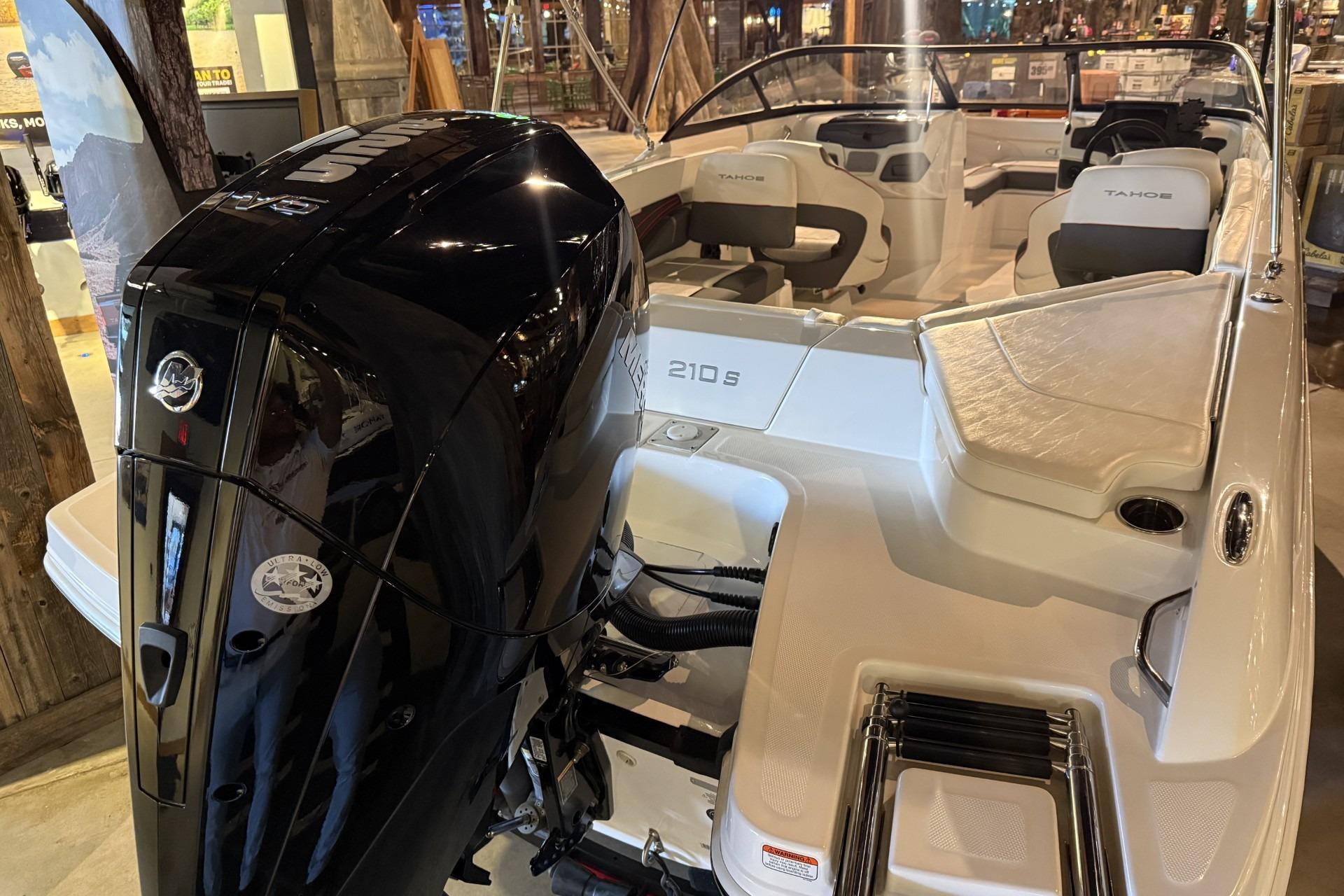 2024 Tahoe 210 S boat with powerful outboard motor, sleek design, and spacious seating.