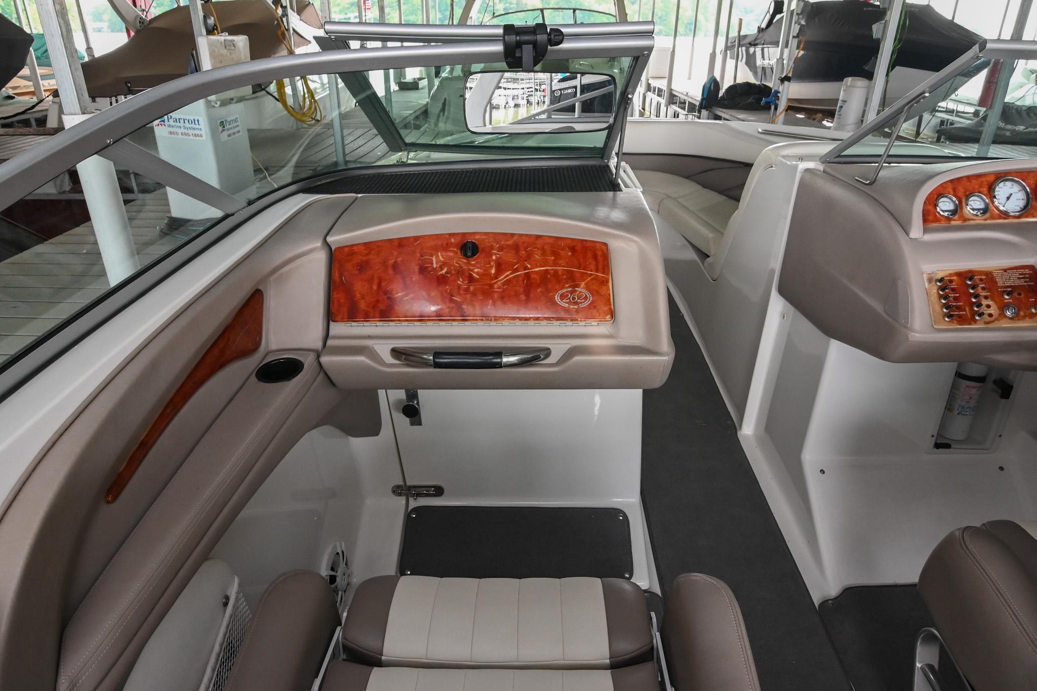 Interior of a 2005 Cobalt 262 boat, featuring sleek seating and wood accents.