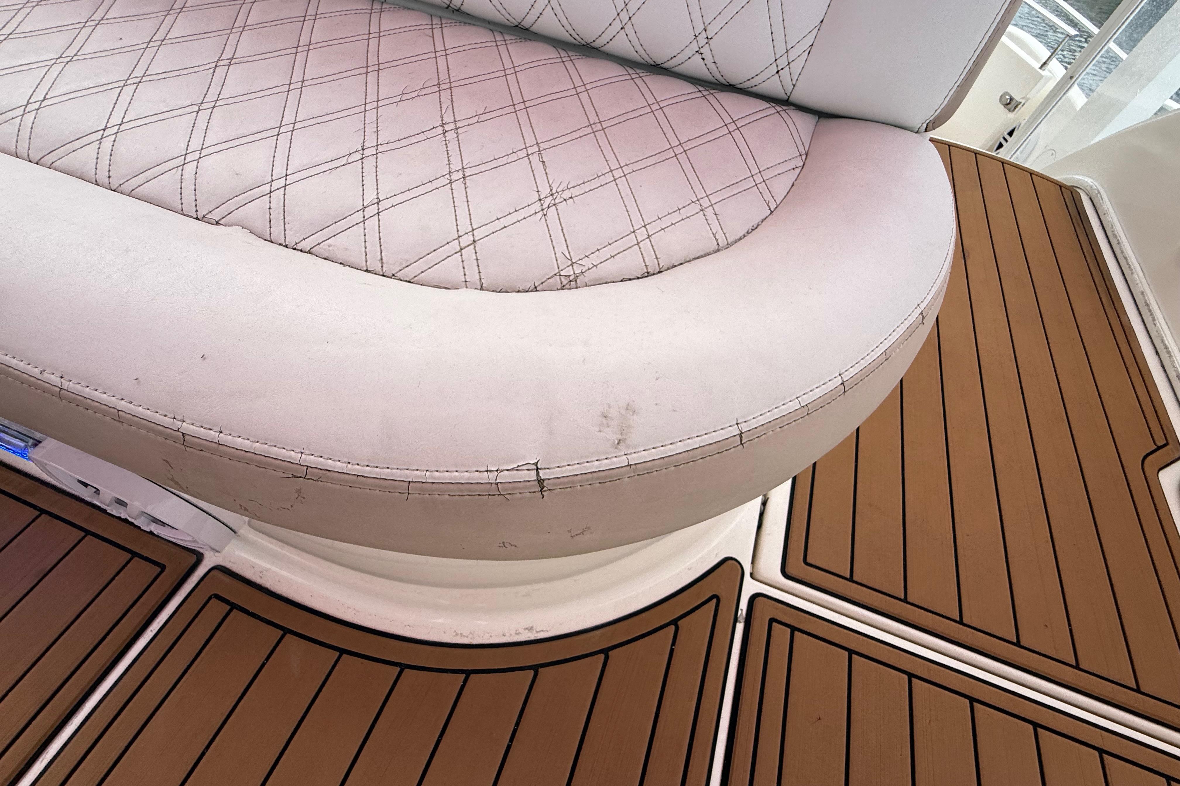 White cushioned seating on 2007 Meridian 459 Motoryacht with teak flooring.