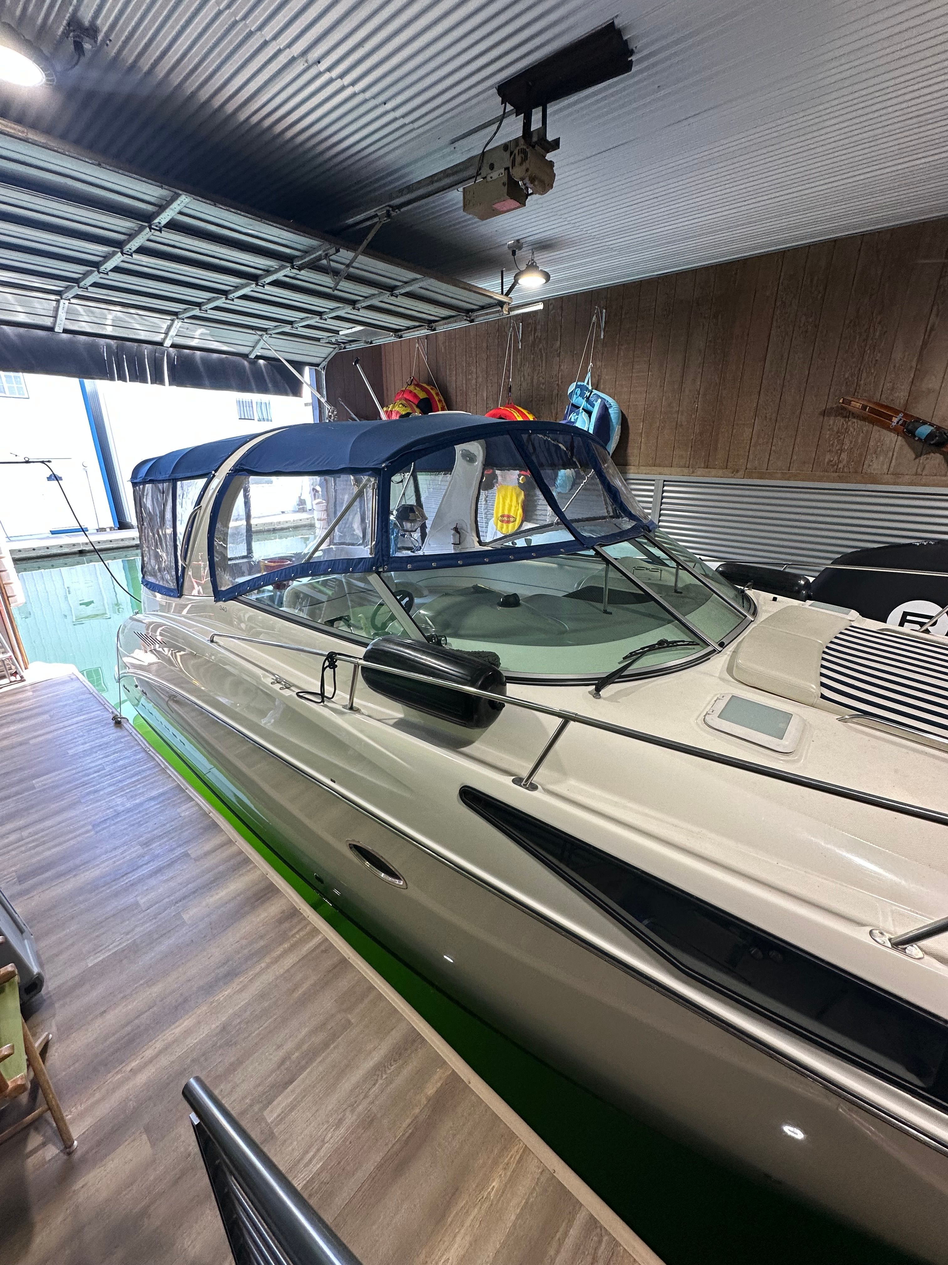 2008 Bayliner 340 boat parked in a garage.