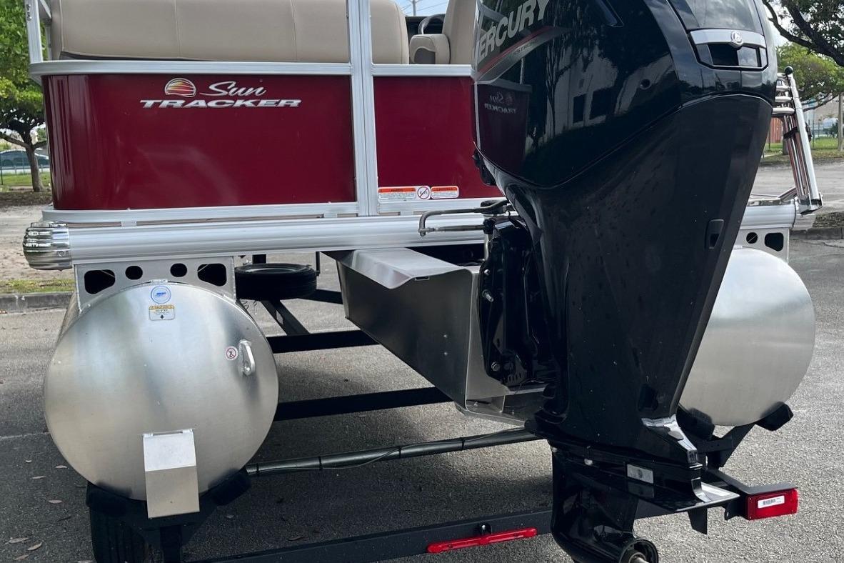2025 Sun Tracker Party Barge 18 DLX with Mercury outboard motor, rear view.