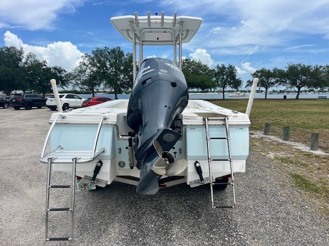 2015 Robalo 246 Cayman with outboard motor and ladders, parked on a lot.