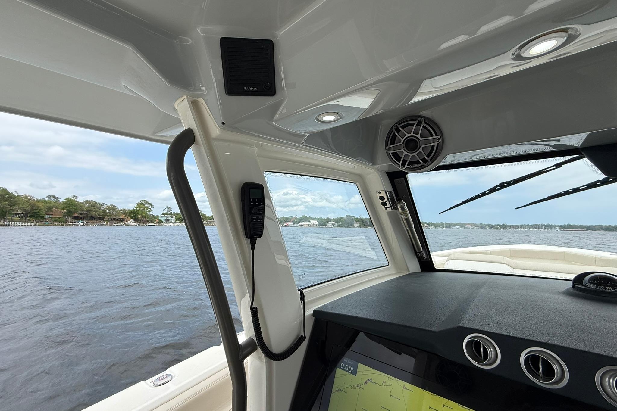 Interior view of 2022 Solace 41CS boat, featuring navigation equipment and scenic waterway.