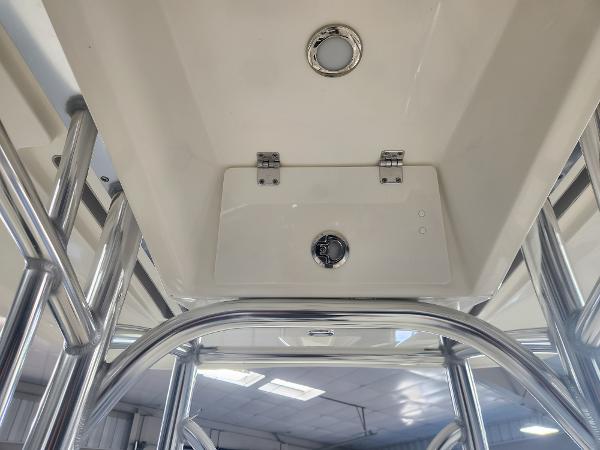 2025 Pathfinder 2400 Open boat interior with stainless steel fixtures and ceiling light.